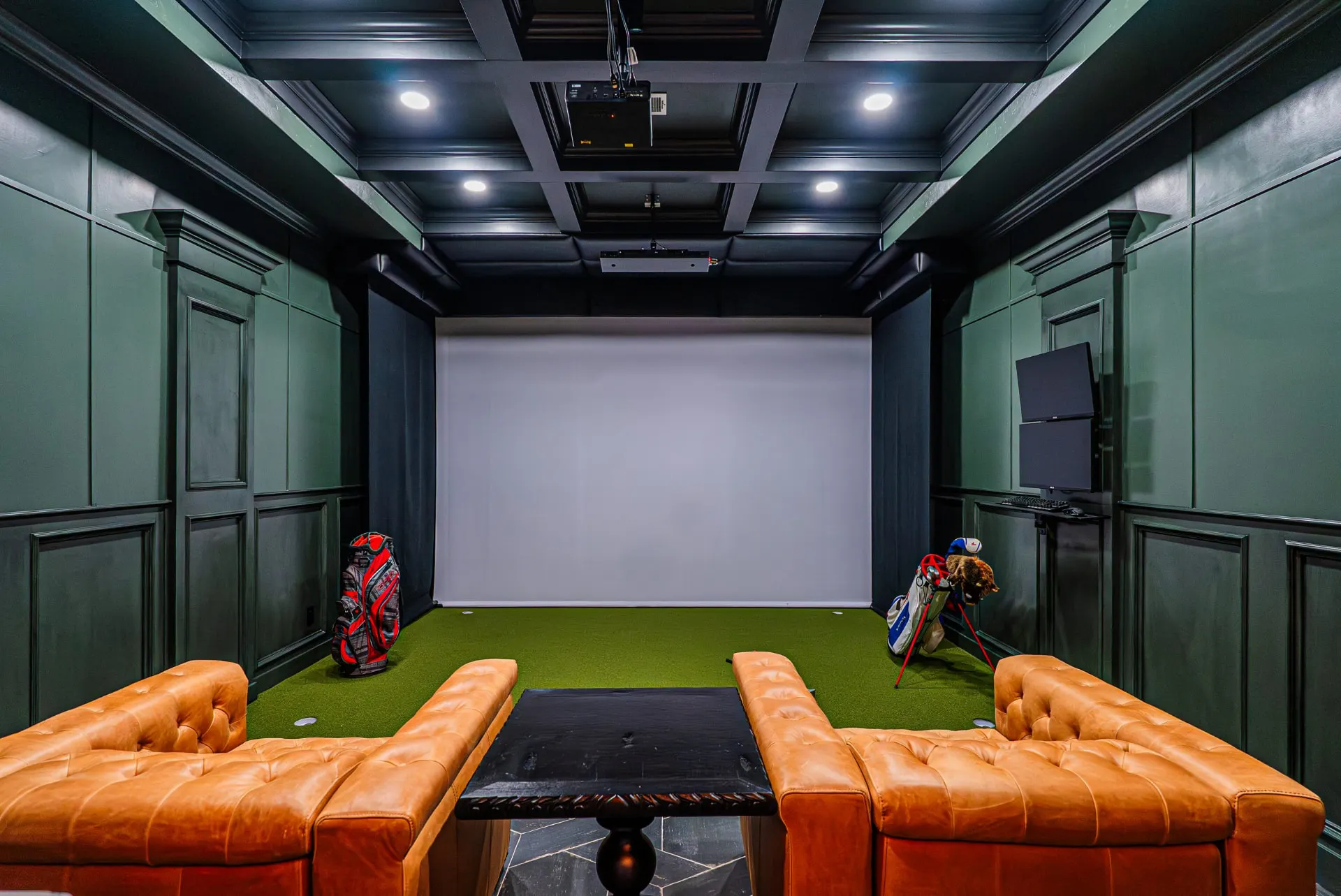 Golf simulator room at 5 Prairie Ln with leather club chairs and projector screen