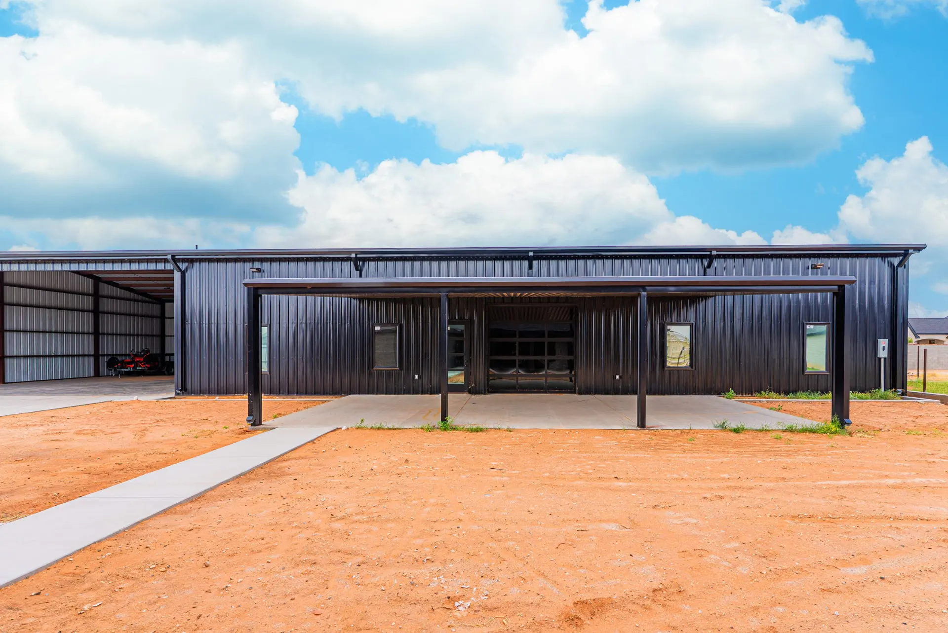 Steel shop with a covered porch and glass overhead door at 1607 NW 12th St