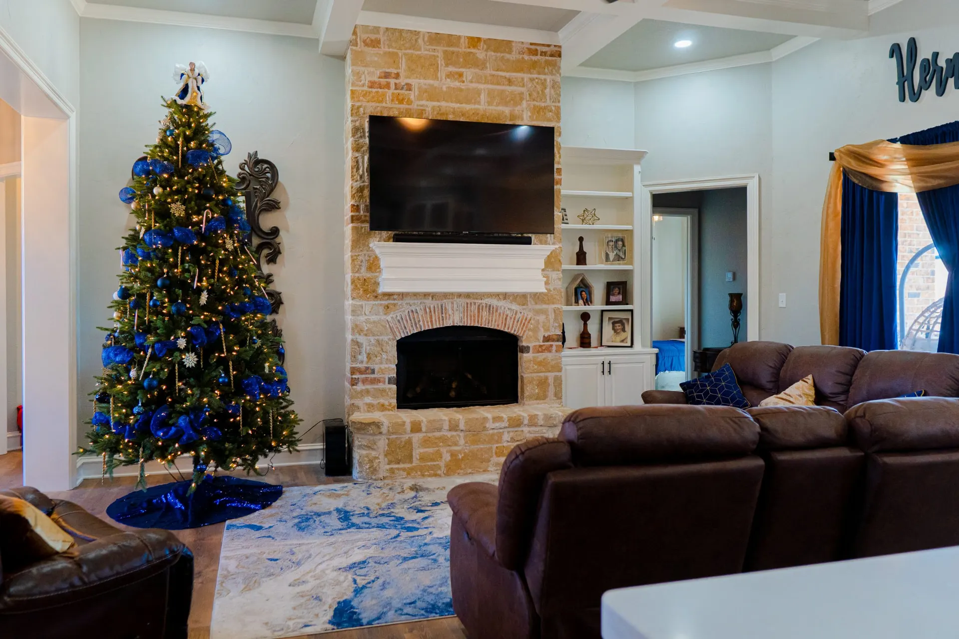 Stone fireplace at 8821 Shawn Dr with a brick arch, white mantel and built-in shelving beside it