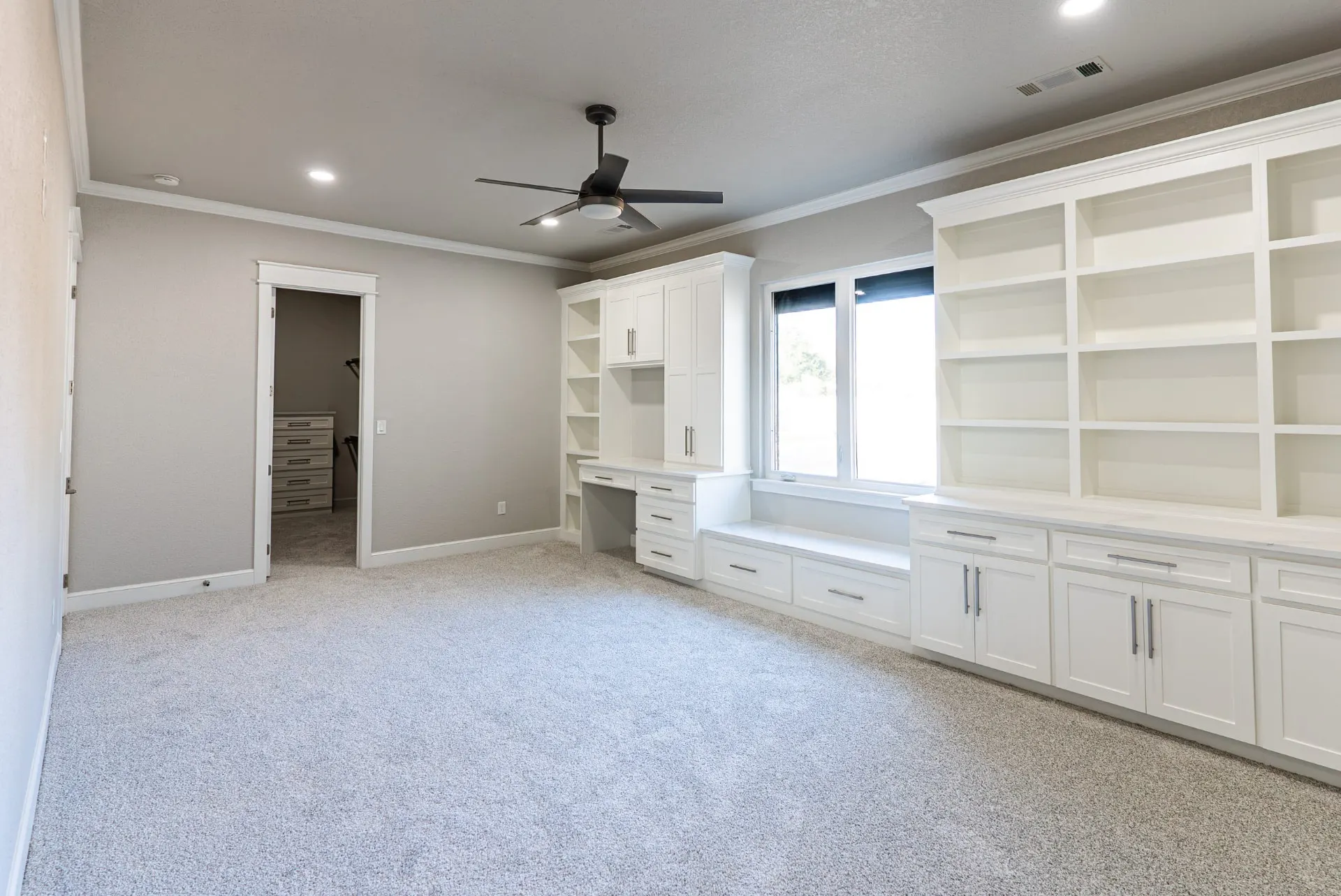Study at 27 Santiago Mission Dr with a built-in wall unit of open shelving and a window seat, opening to a walk-in closet