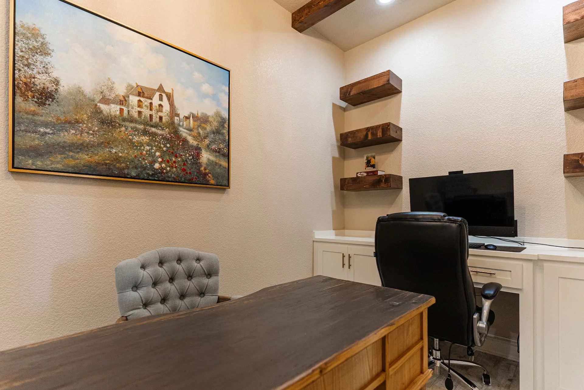 Home office with desk and built-in shelving at The Flores Estate