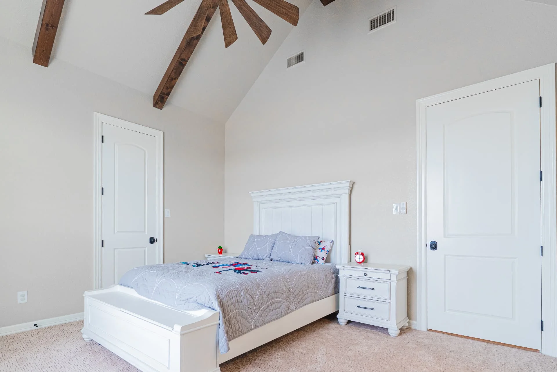 Bedroom with ceiling beams and white furniture at The Flores Estate