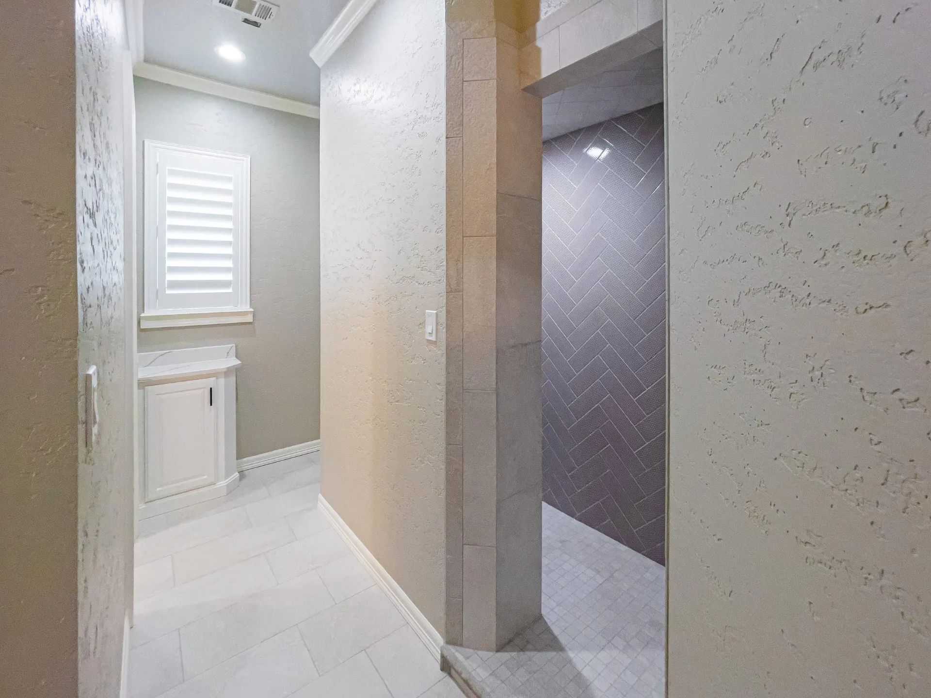 Bath passage with a herringbone-tiled walk-in shower at 1501 NW 12th St