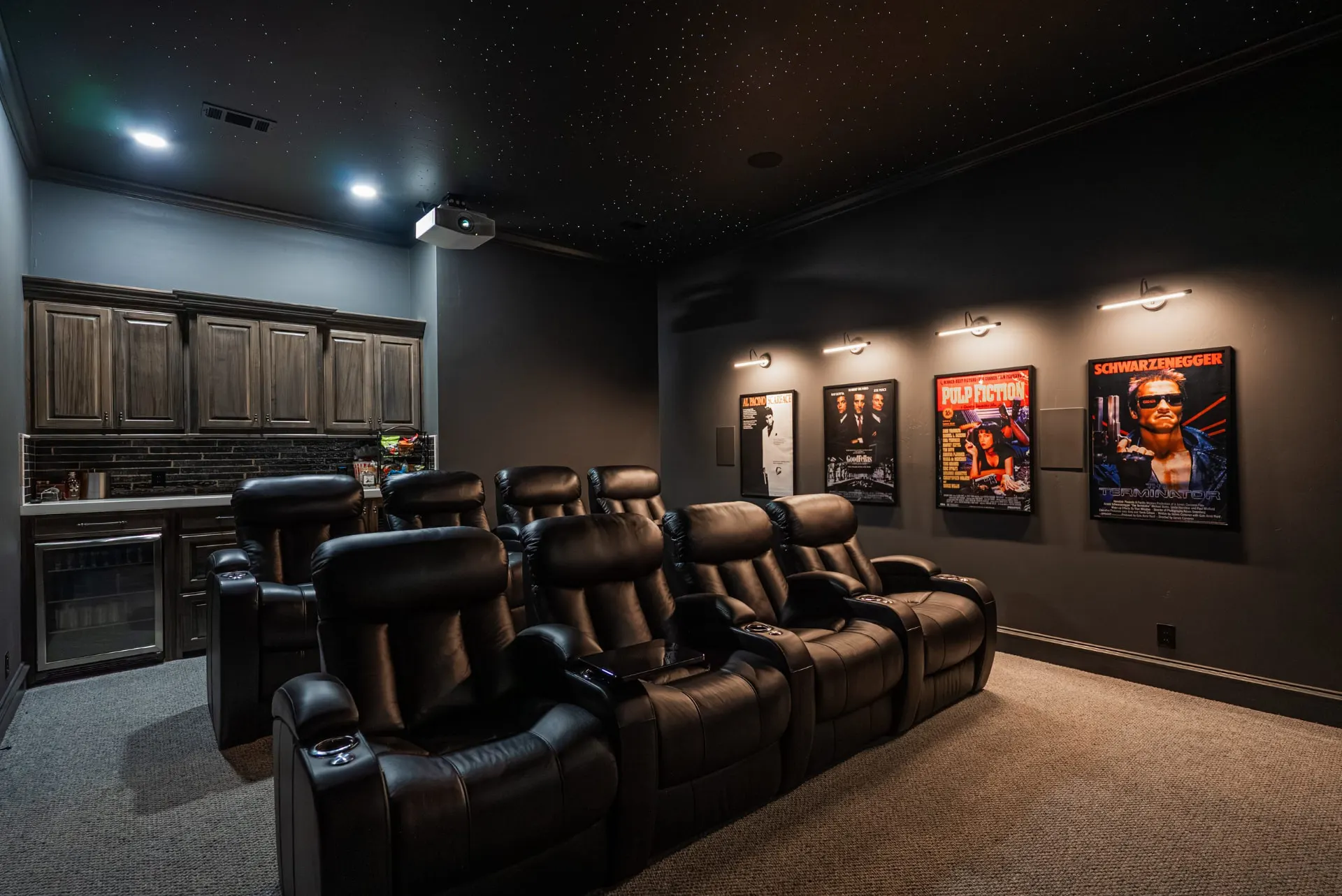 Home theater at 1610 NW Eliam Dr with two rows of leather recliners, star-field ceiling and a snack bar