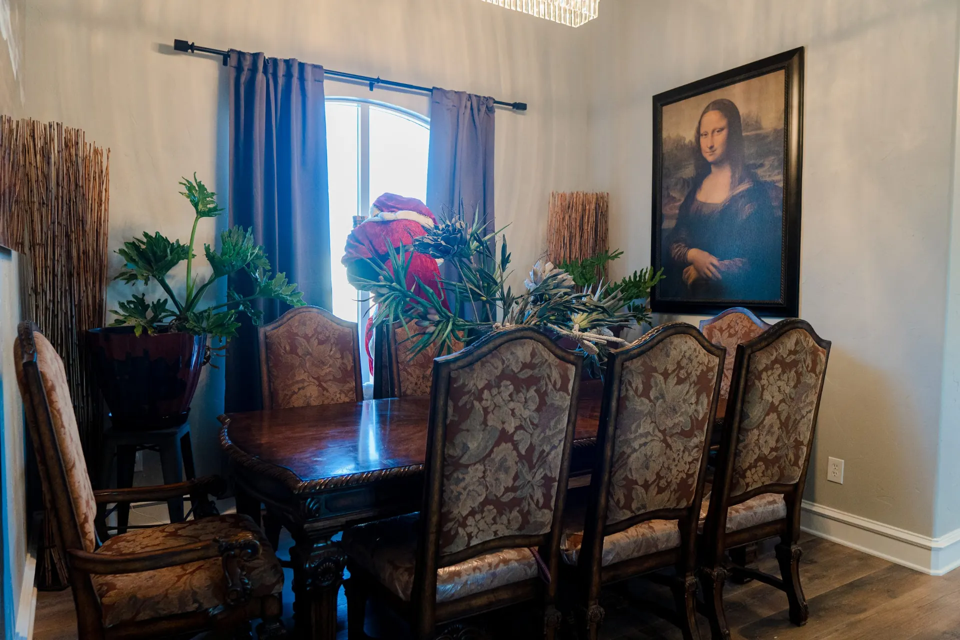 Dining room at 8821 Shawn Dr with an arched window and a crystal chandelier