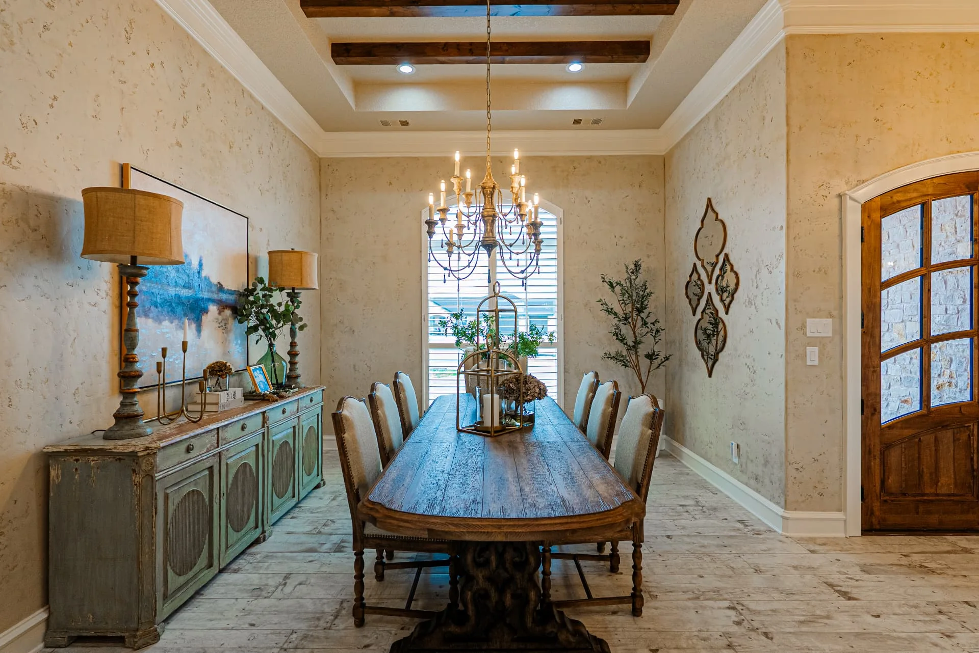 Dining room at The Flores Estate with long wood table and ceiling beams