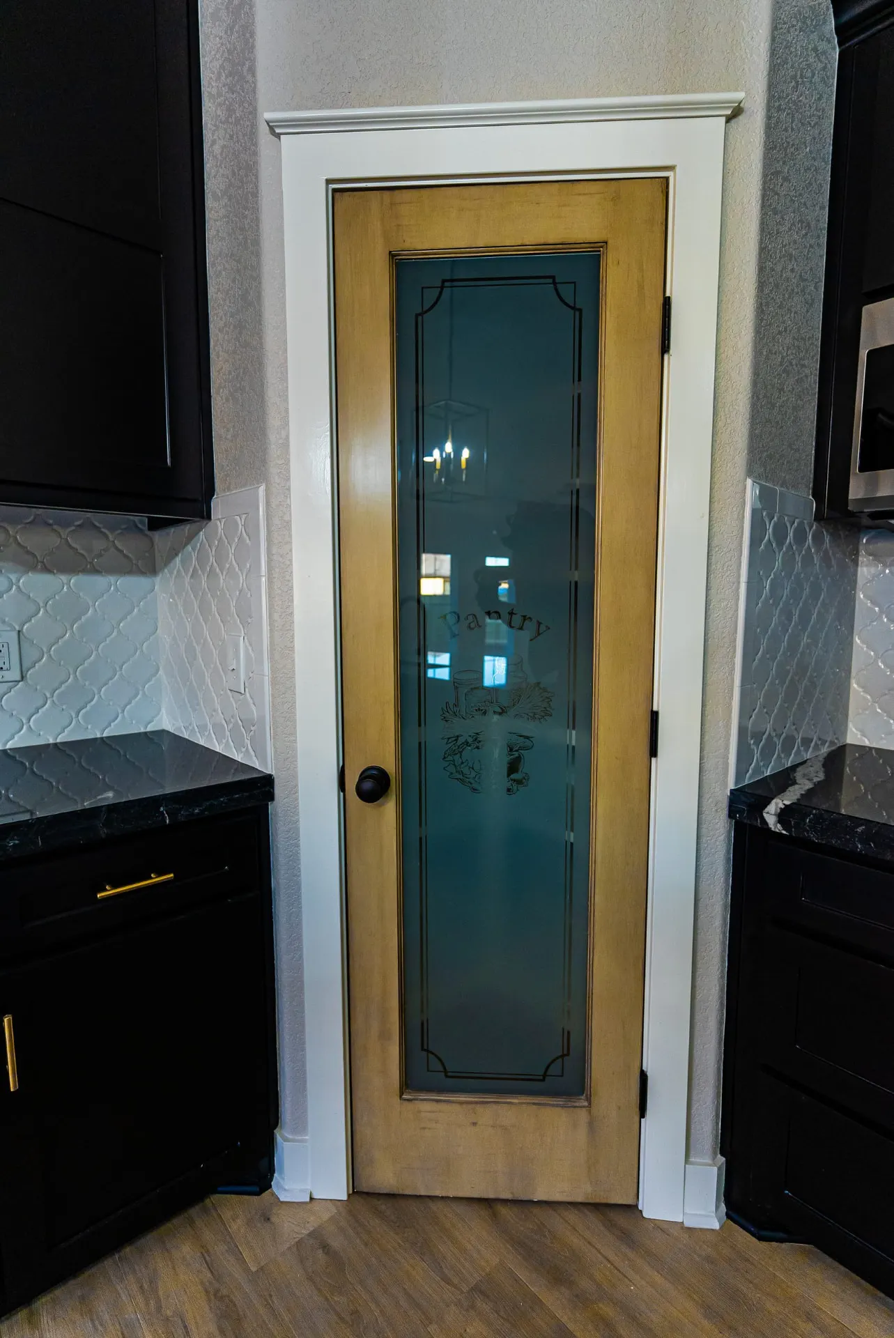 Pantry door at 708 K Ave with etched glass over a stained wood frame
