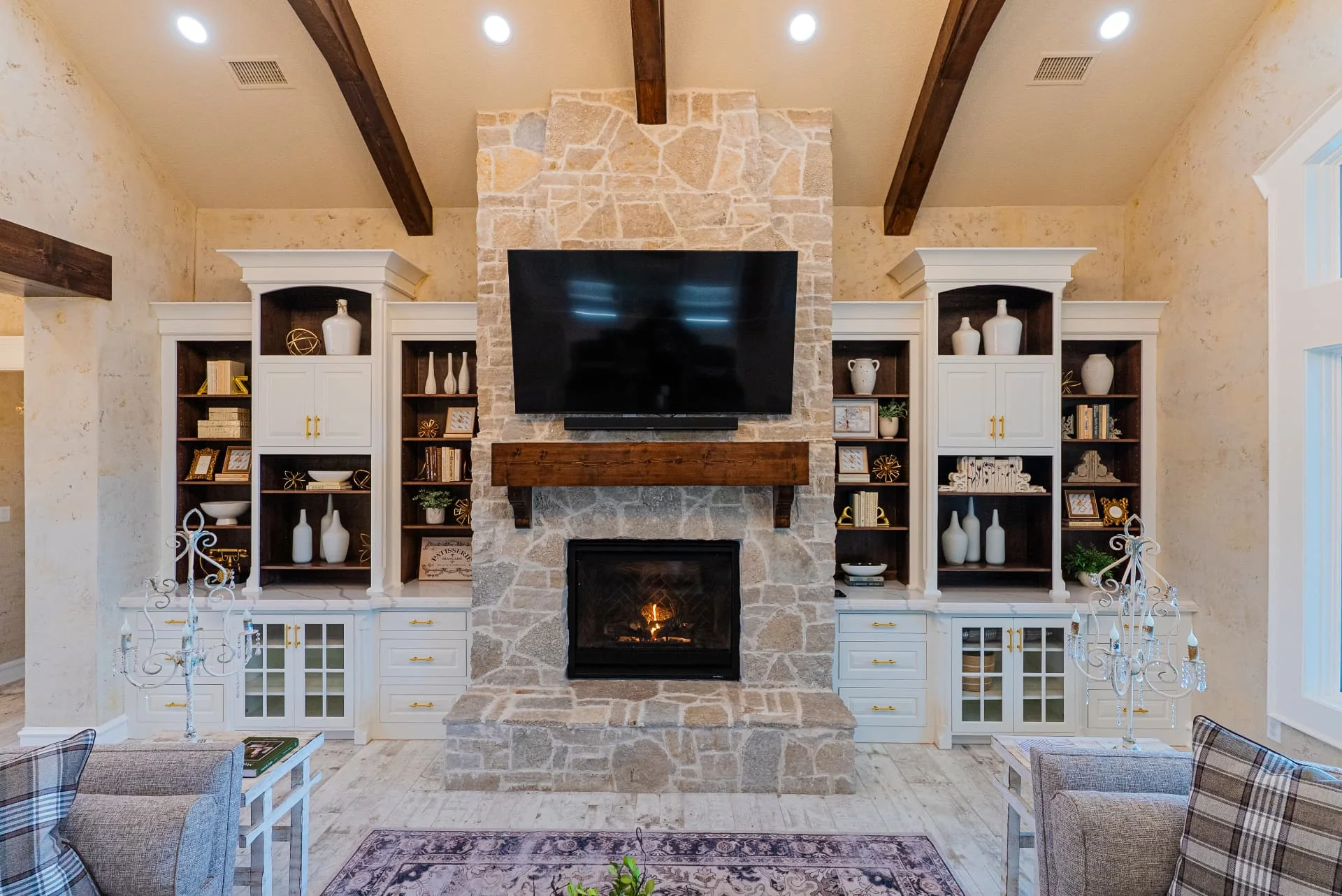 Living room fireplace, cabinetry and ceiling beams at The Flores Estate