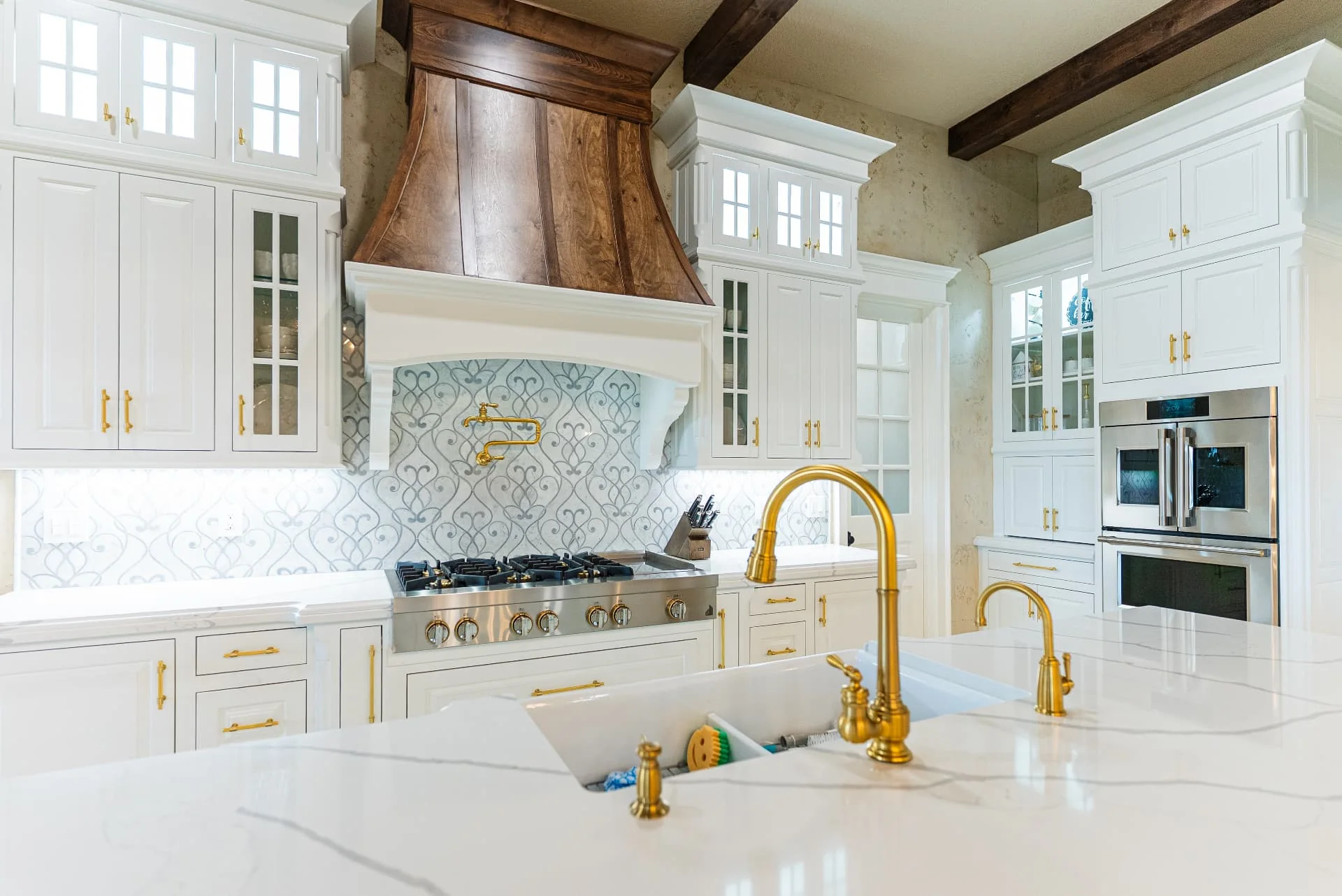 Kitchen island sink and gold faucet at The Flores Estate