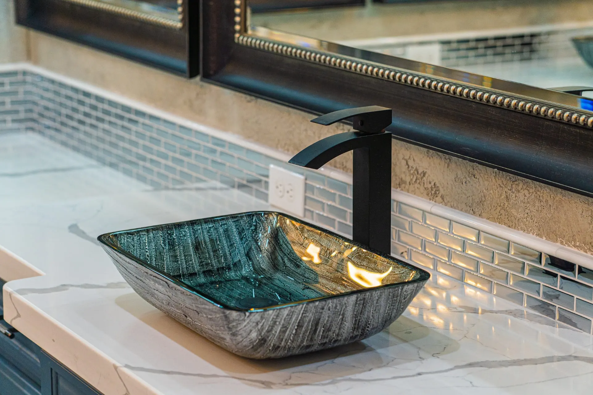 Textured glass vessel sink with matte-black waterfall faucet at 1501 NW 12th St