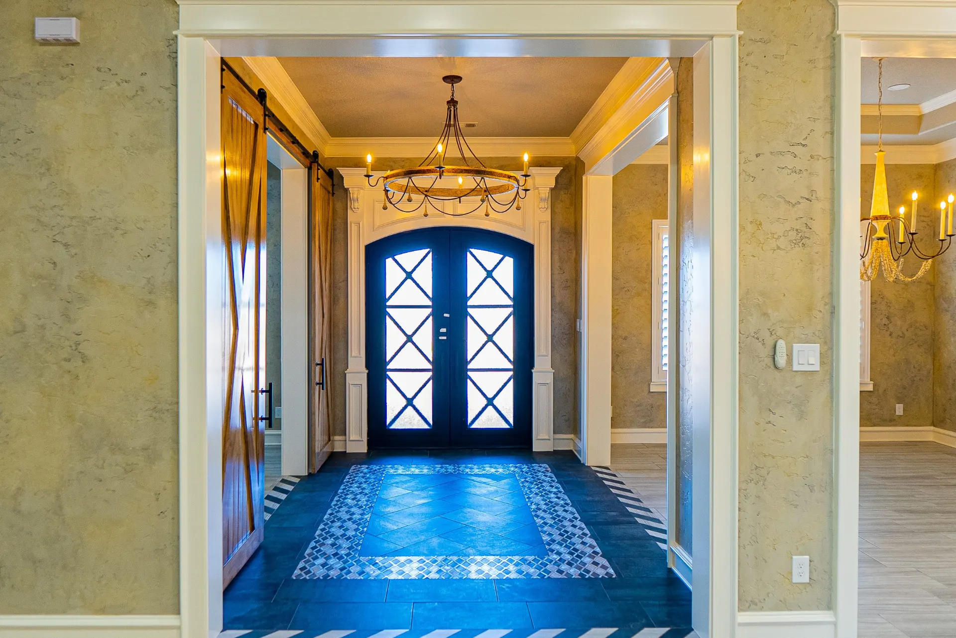 Entry at 1501 NW 12th St with navy iron double doors, blue tile floor and barn-door hallway