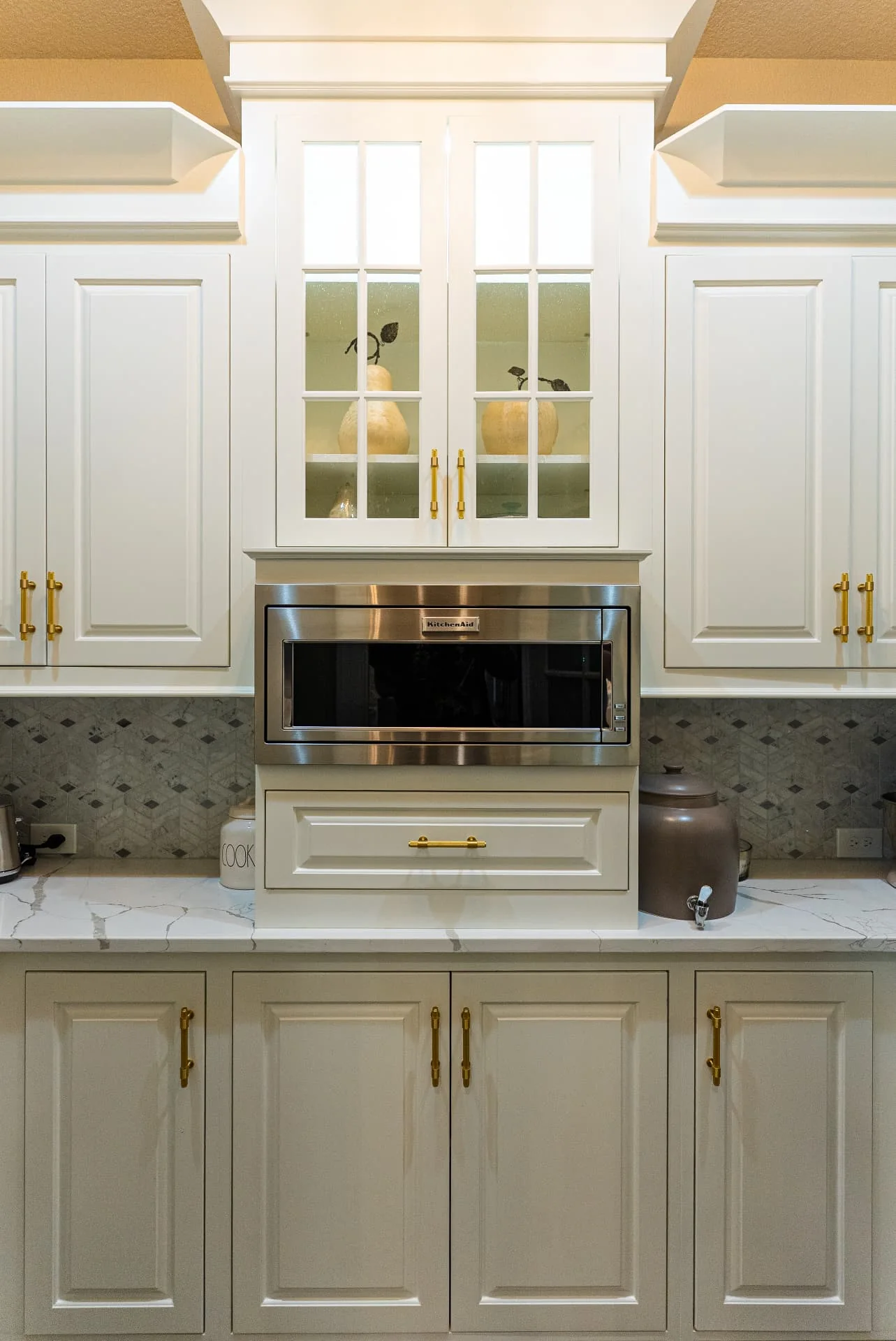 Built-in kitchen cabinetry and microwave at The Flores Estate