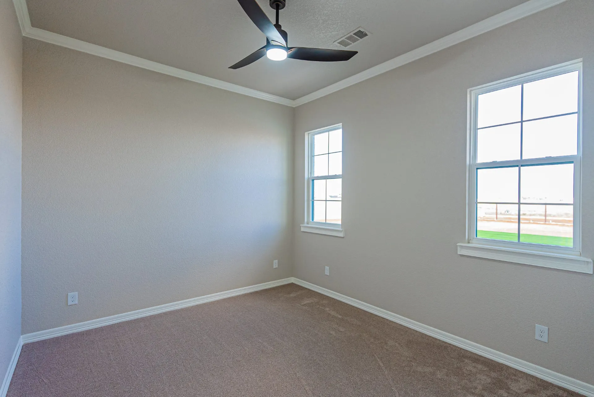 Bedroom at 1602 NW 12th St with tray ceiling, black ceiling fan, dual windows and carpeted floors