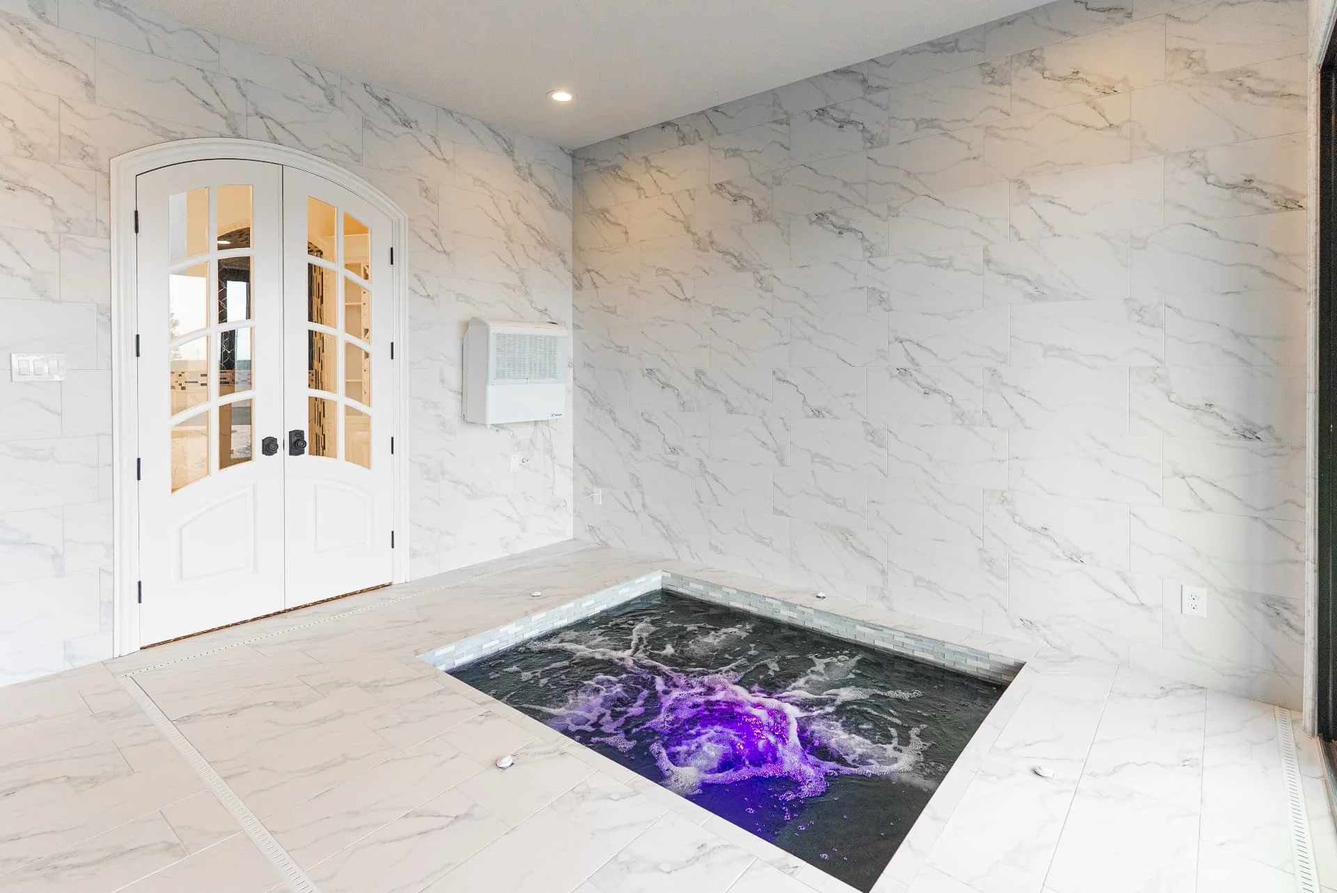 Indoor spa surrounded by stone tile at The Flores Estate