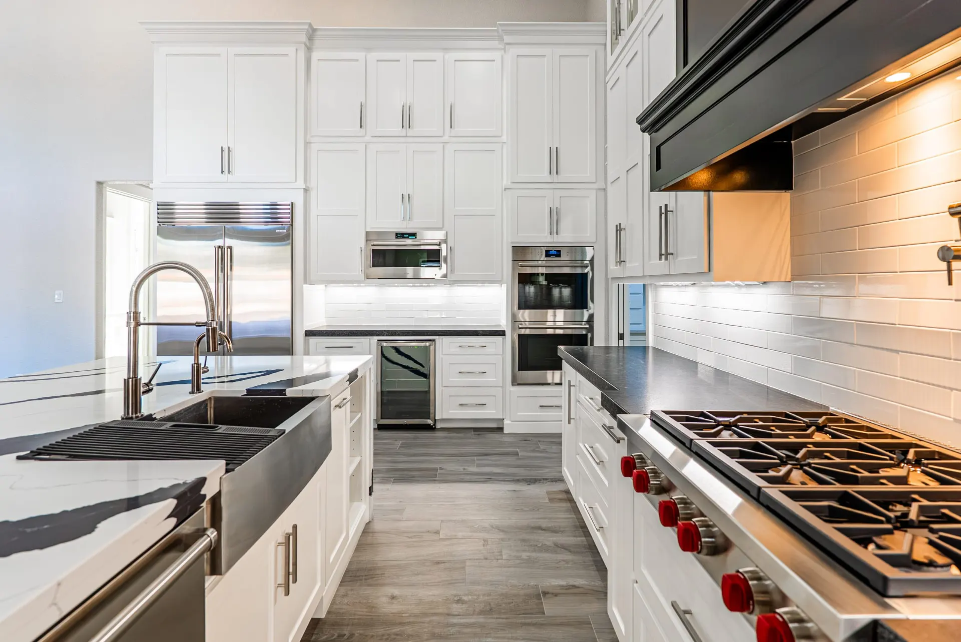 Kitchen at 27 Santiago Mission Dr with a farmhouse workstation sink, wine fridge and red-knobbed Wolf rangetop