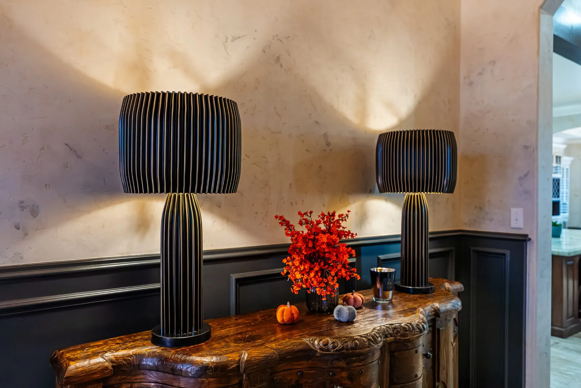 Carved console with ribbed table lamps in the entry at 5 Prairie Ln