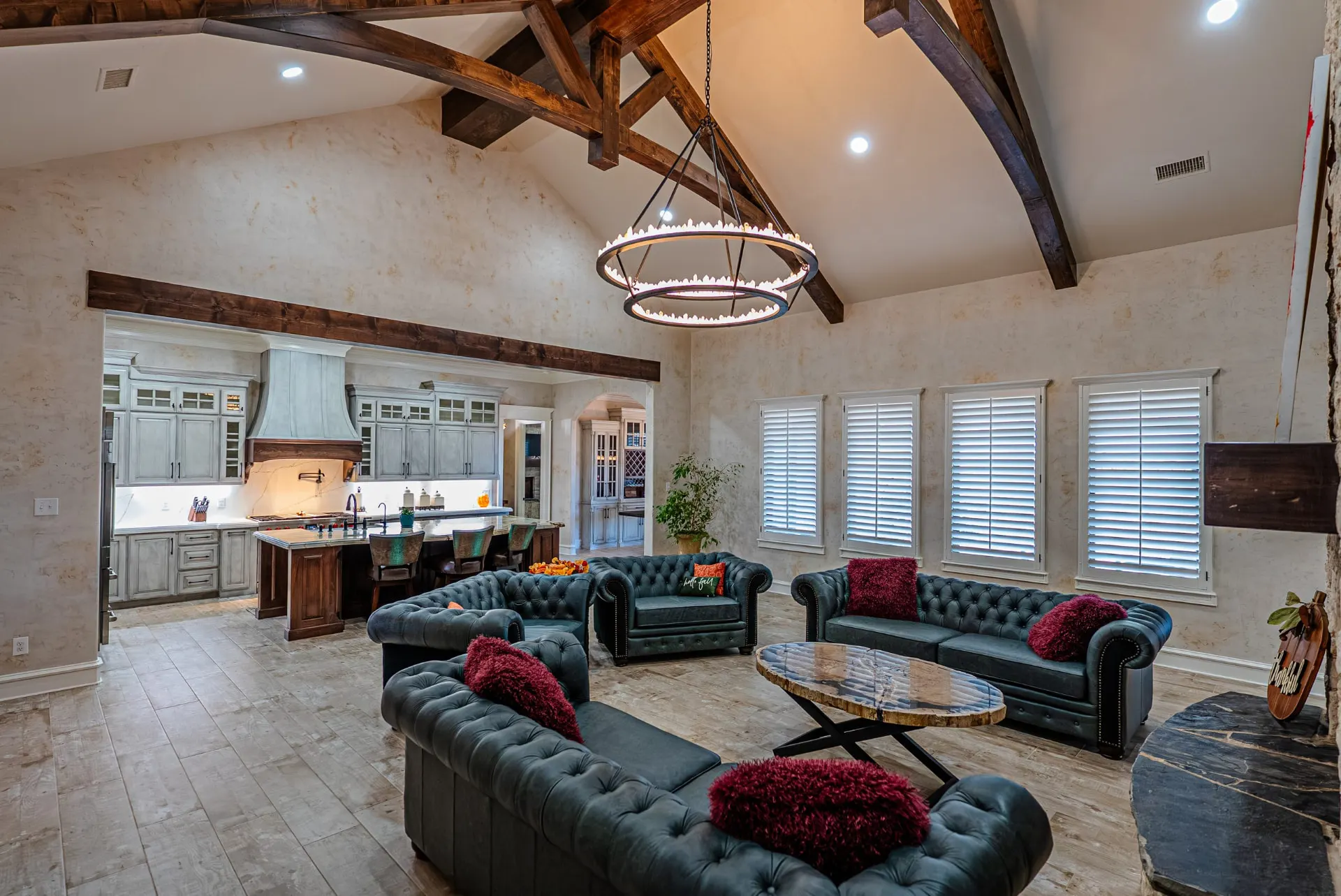 Living room at 5 Prairie Ln with plantation shutters and kitchen beyond