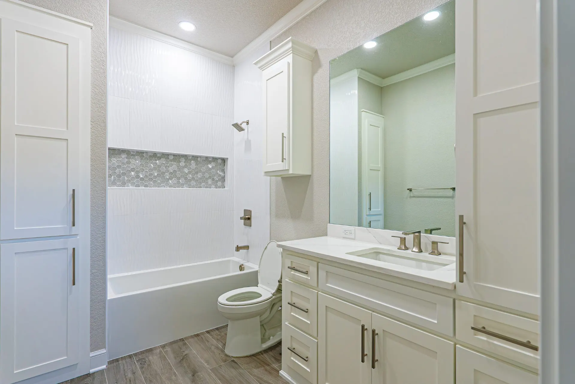Bathroom at 27 Santiago Mission Dr with wavy white tile, a hexagon mosaic niche and white shaker vanity
