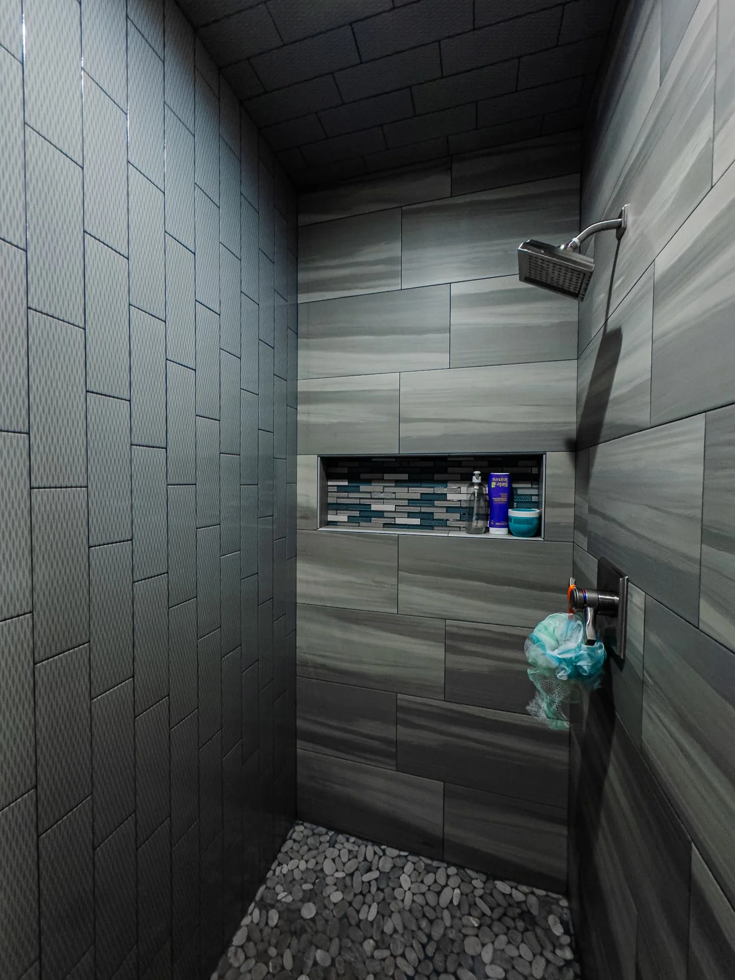 Tiled shower with built-in shelves at The Flores Estate