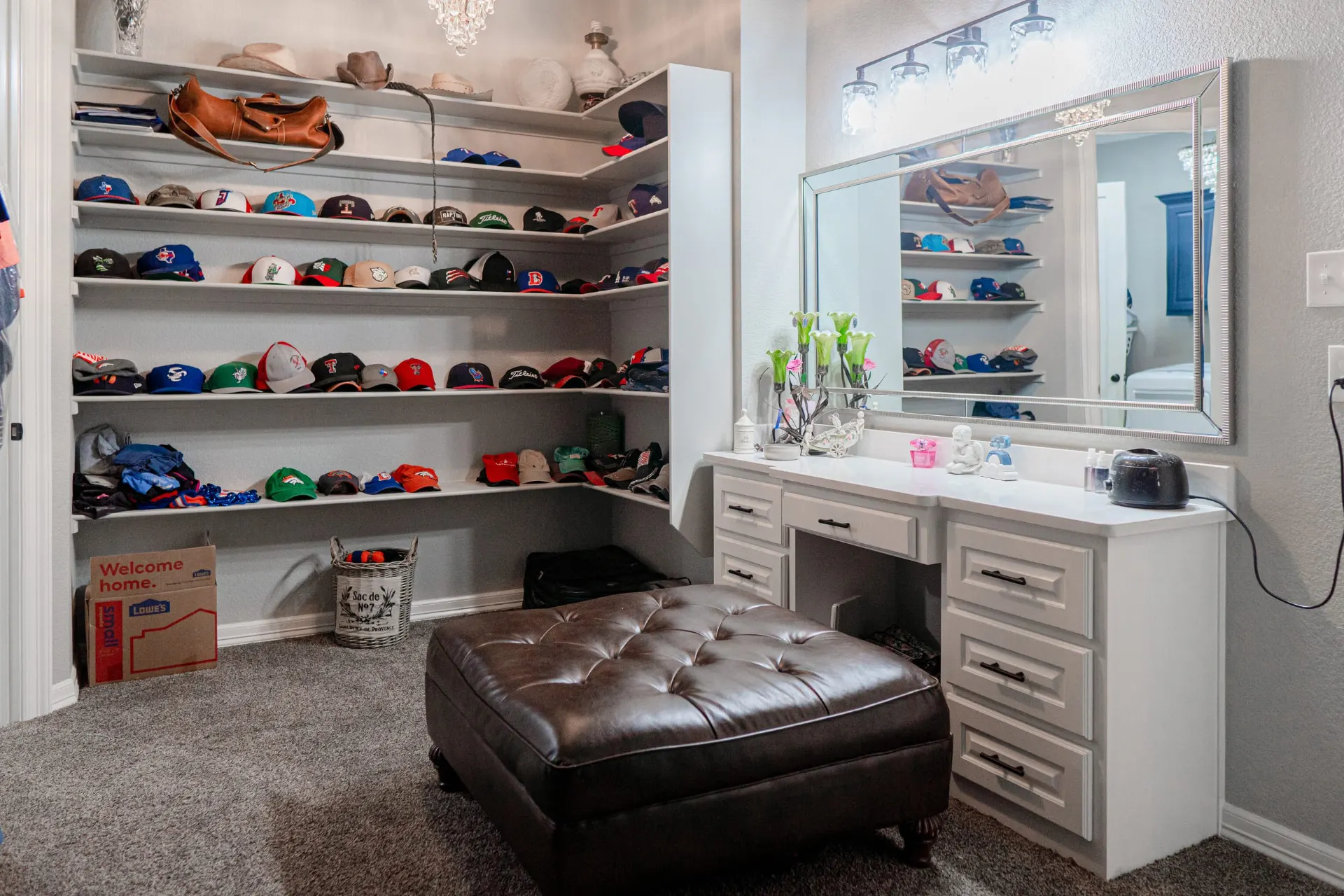 Dressing area with a built-in white makeup vanity, corner display shelving and a crystal chandelier at 8821 Shawn Dr