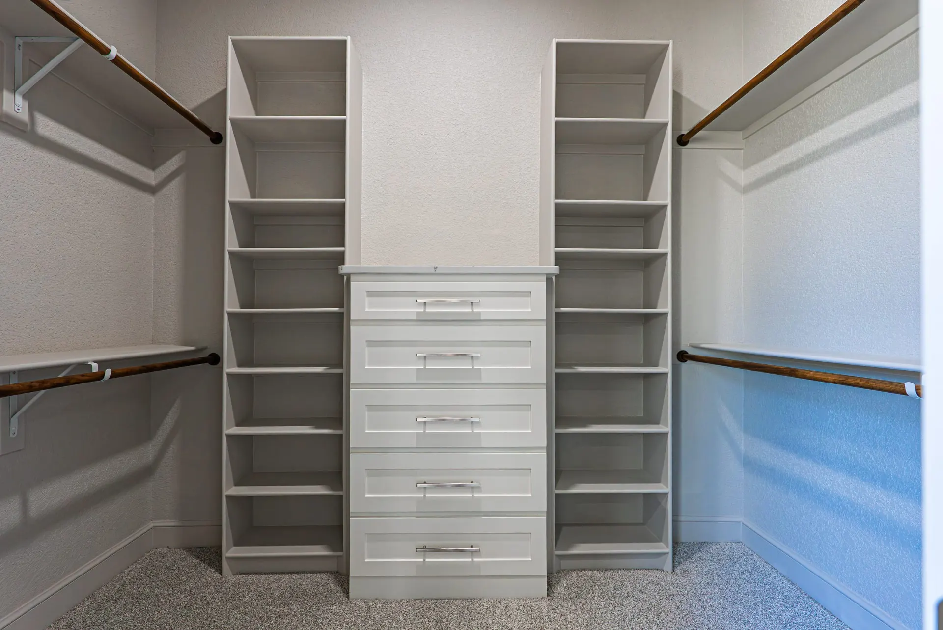 Walk-in closet at 27 Santiago Mission Dr with shelving towers and a central drawer stack