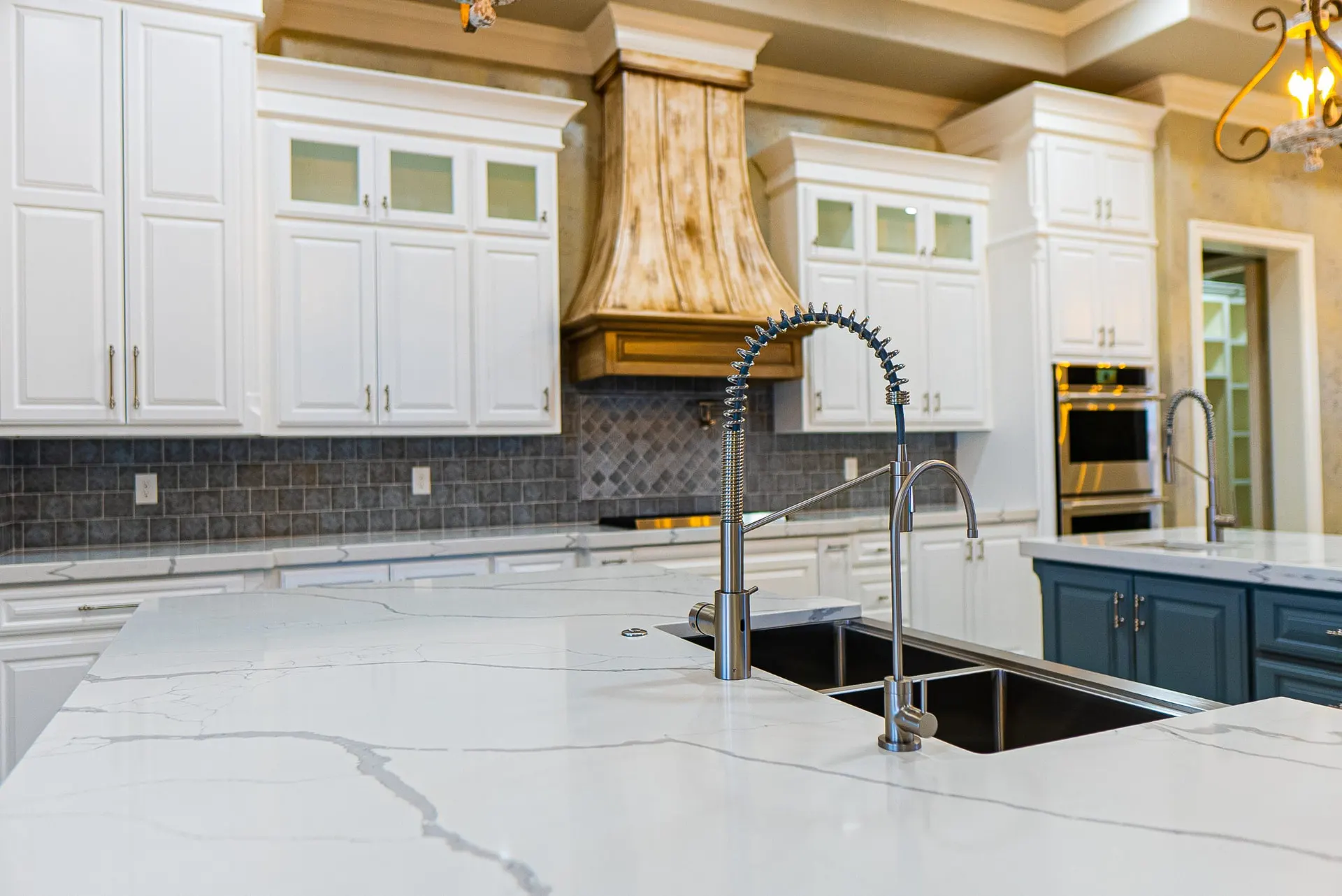 Pull-down spring faucet and undermount sink on the white quartz island at 1501 NW 12th St