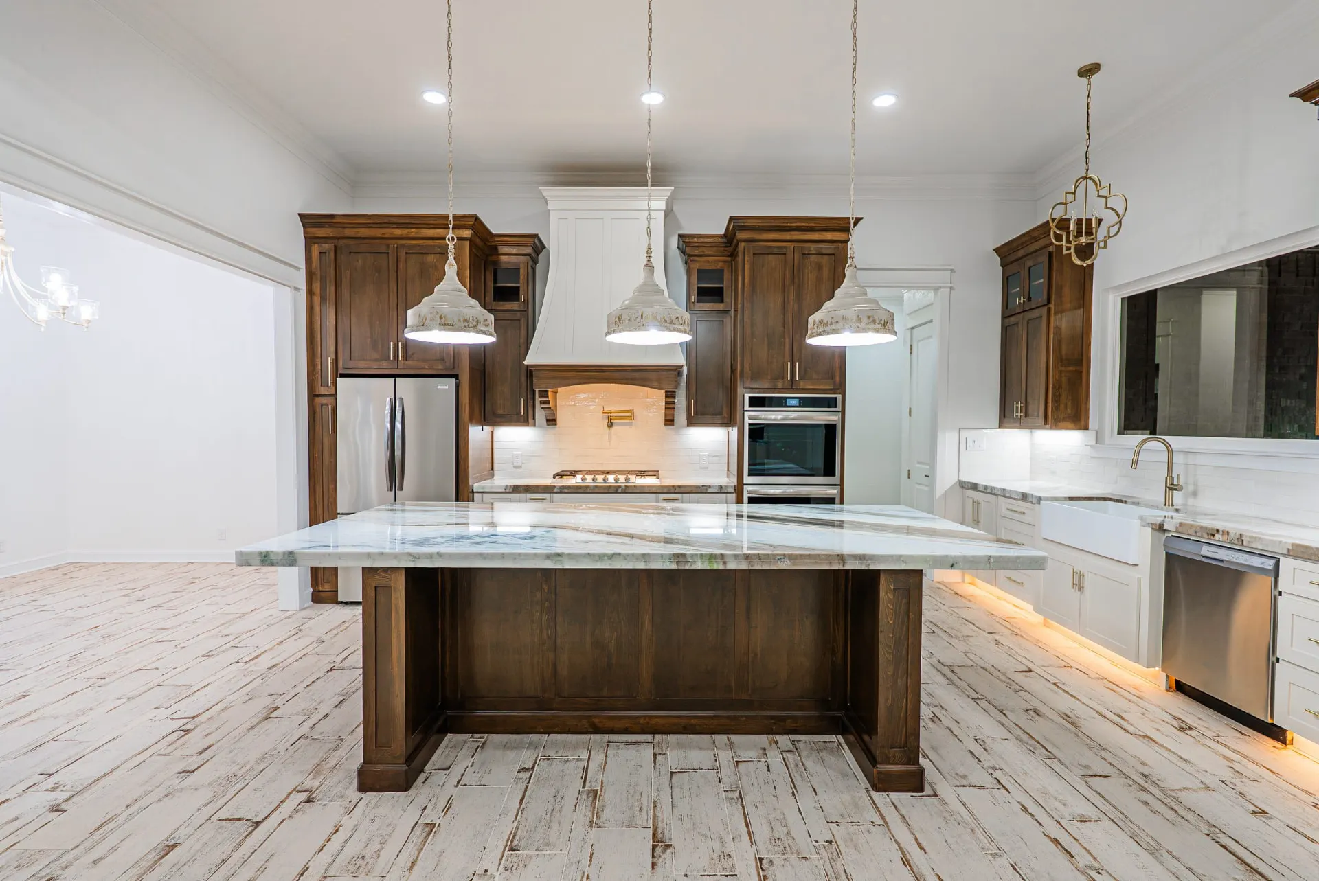 Kitchen at 1607 NW 12th St with espresso perimeter cabinets, white island and quartzite counters