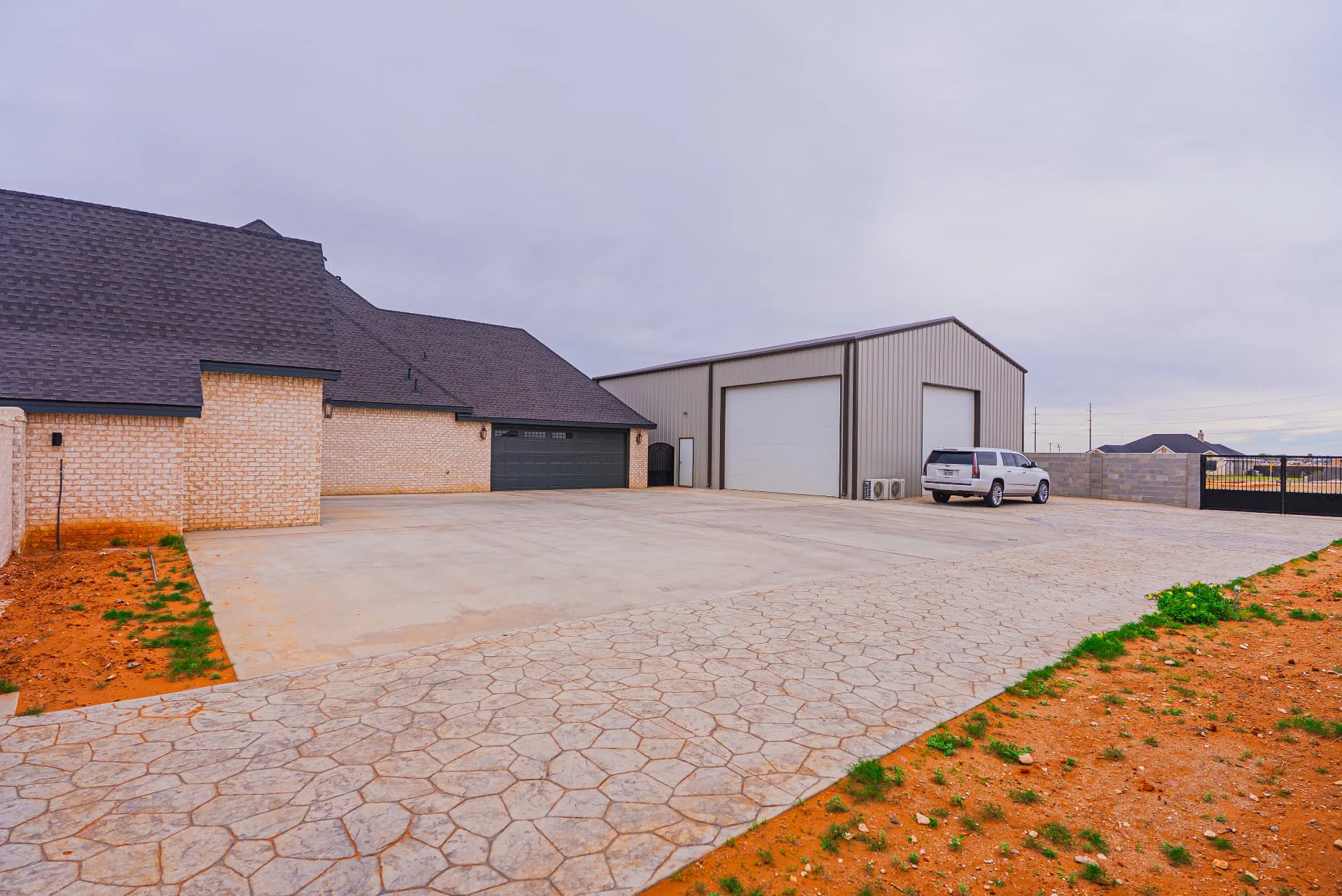 Paved side driveway and detached metal building at The Flores Estate