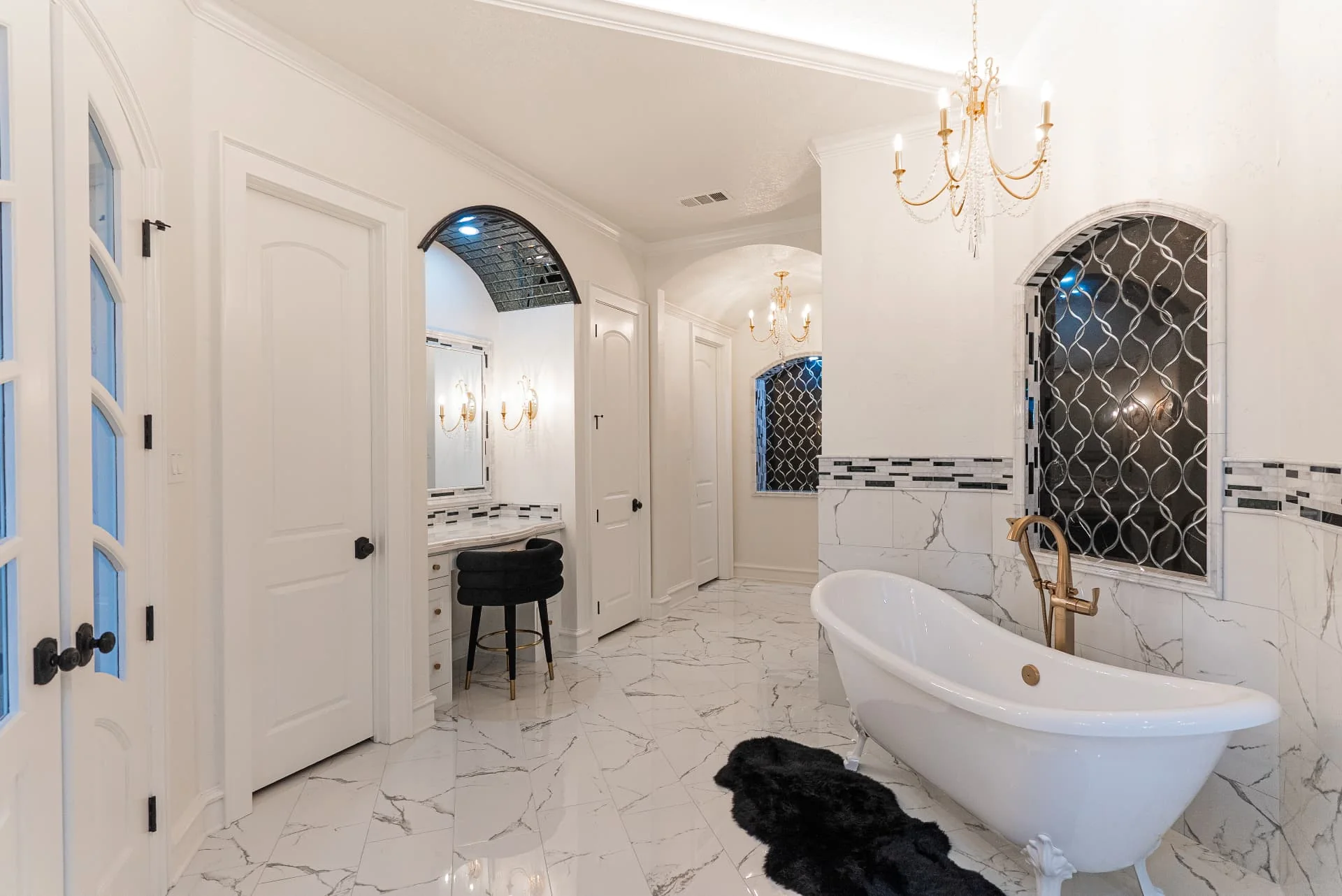 Bathroom with freestanding tub and chandelier at The Flores Estate