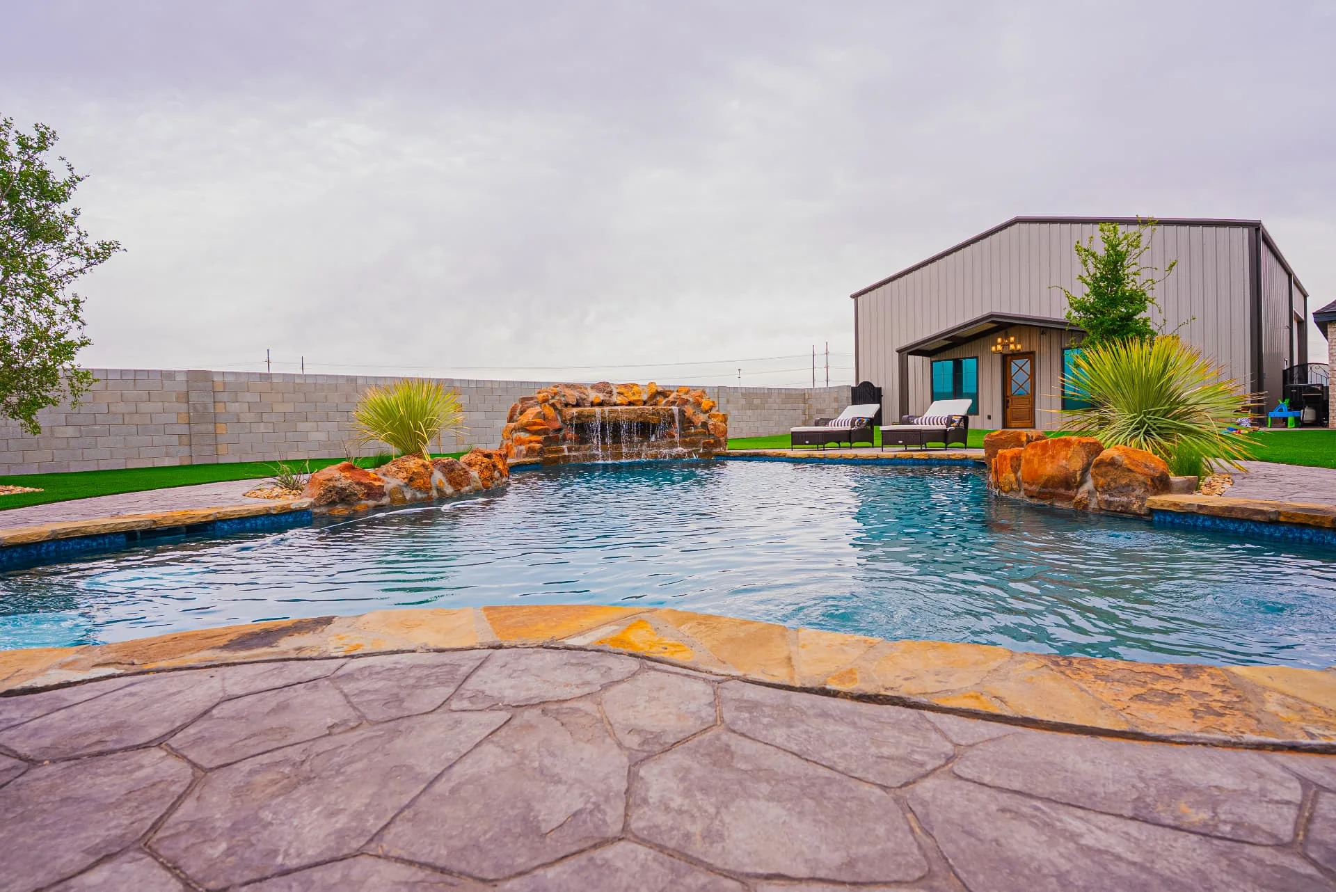 Pool waterfall and stone surround at The Flores Estate