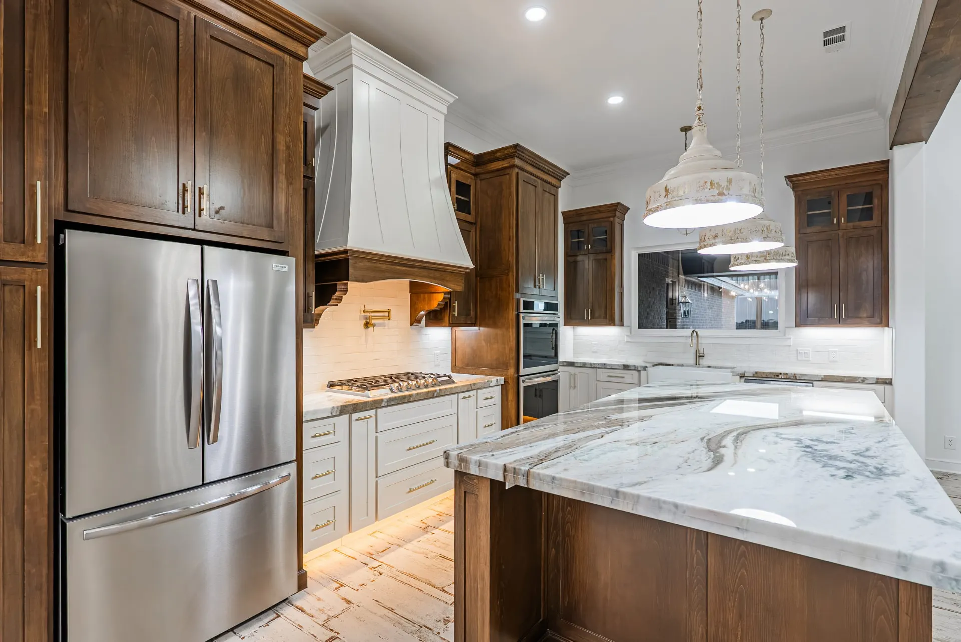 Espresso cabinetry and carved white hood around the range at 1607 NW 12th St