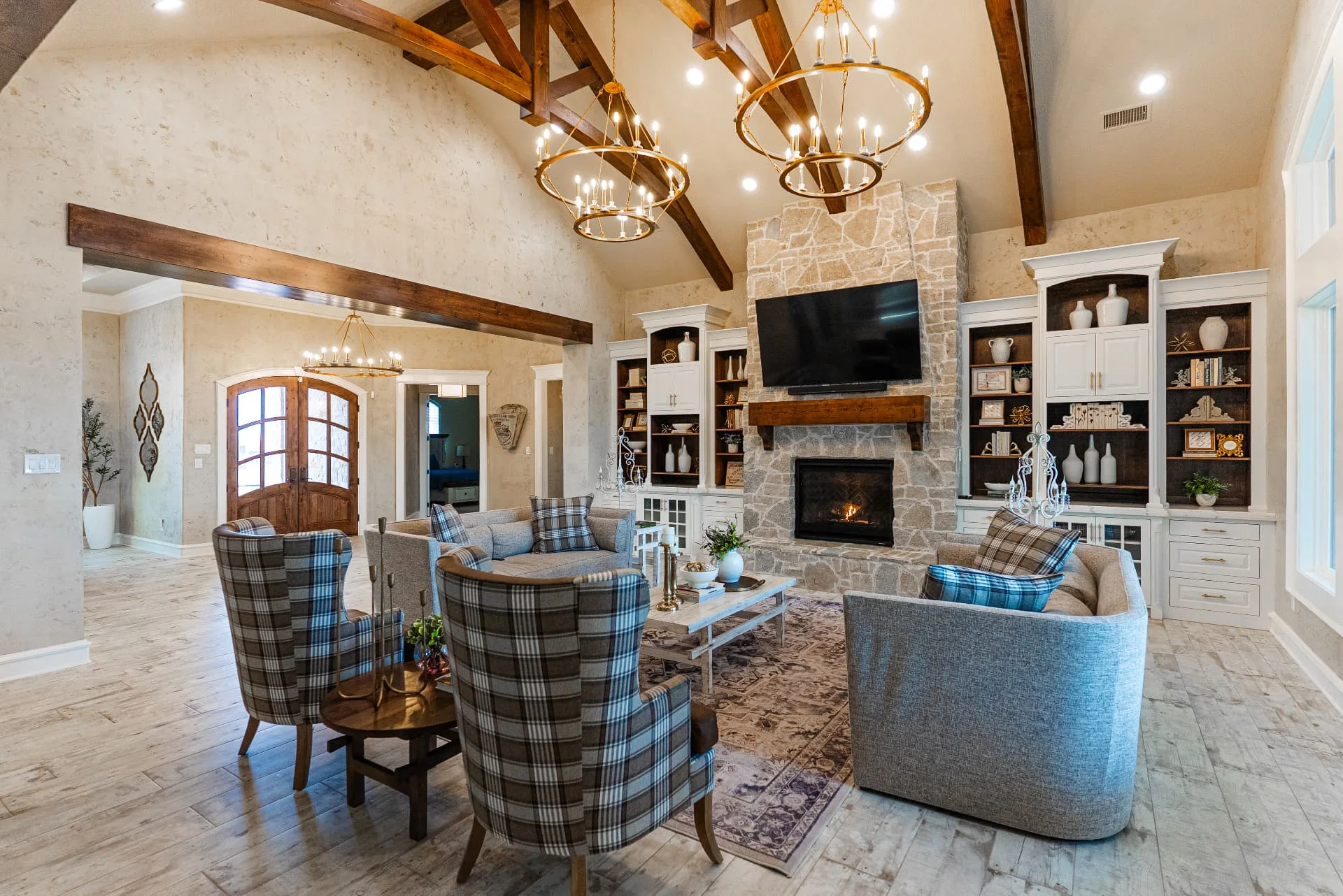Living room seating and stone fireplace at The Flores Estate