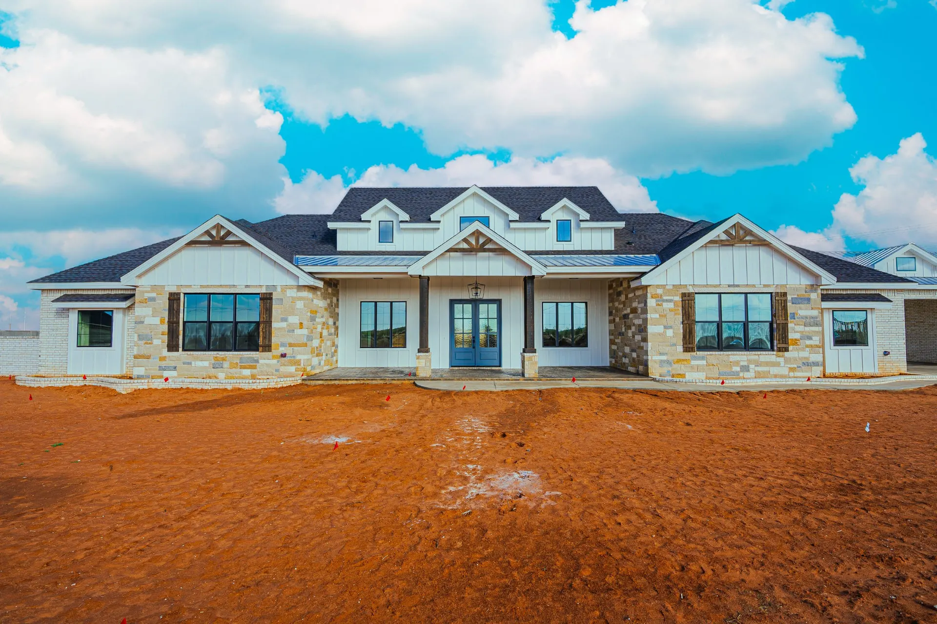Close front view of 1602 NW 12th St with glass-and-wood double doors under the covered entry porch