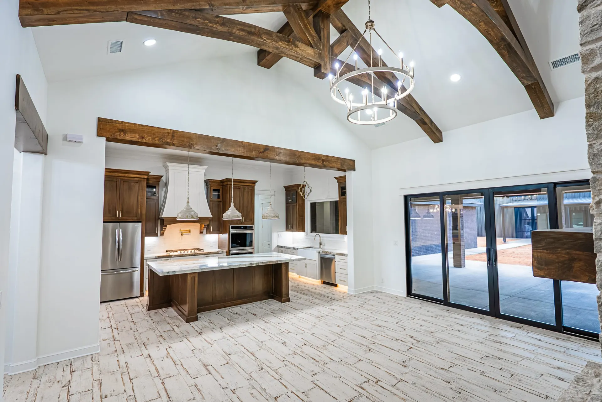 Vaulted great room at 1607 NW 12th St with glass doors opening to the patio