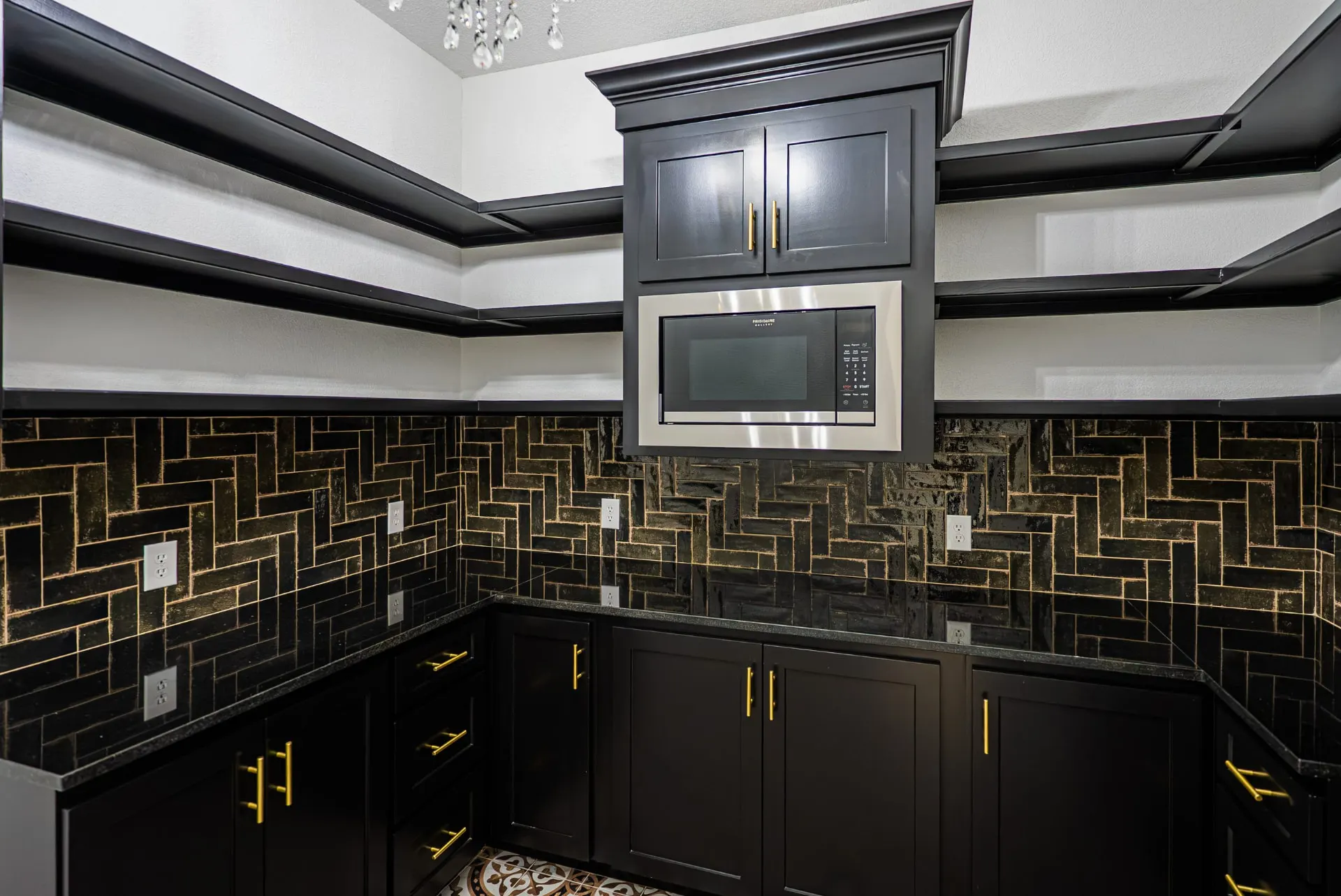Butler's pantry in matte black cabinetry with gold hardware and brick-pattern tile at 1607 NW 12th St