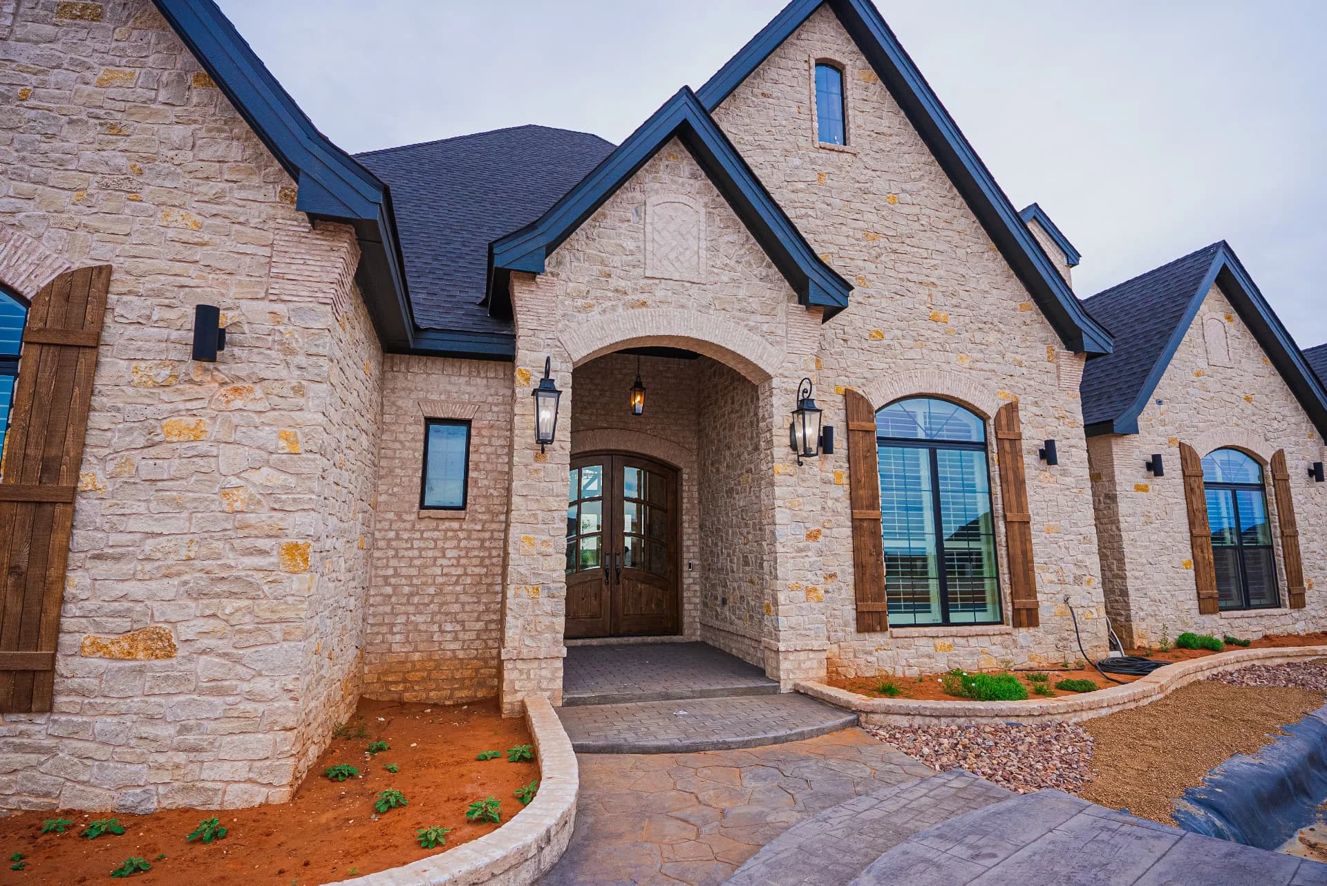 Front entrance and stone facade at The Flores Estate