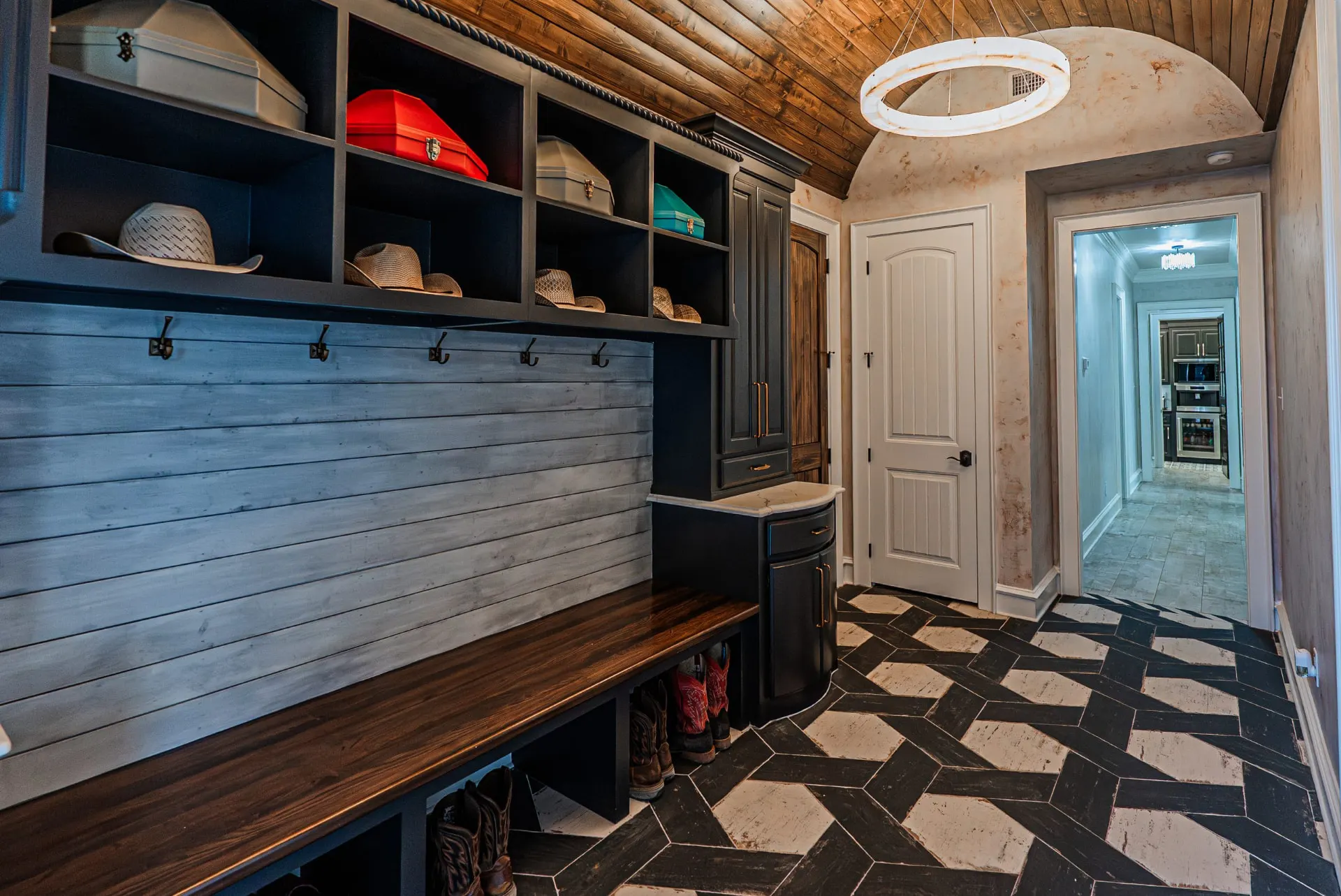 Boot bench and hat shelves in the mudroom at 5 Prairie Ln