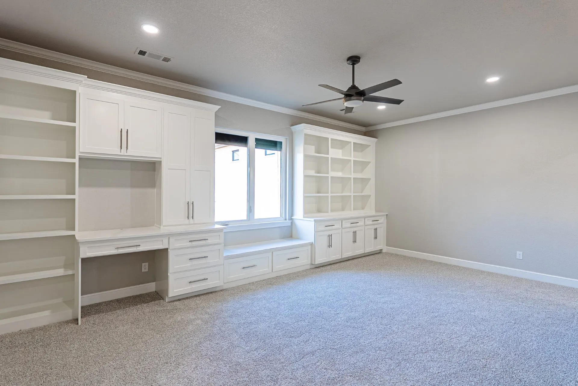 Home office at 27 Santiago Mission Dr with built-in white cabinetry, an integrated desk and a window bench with drawers