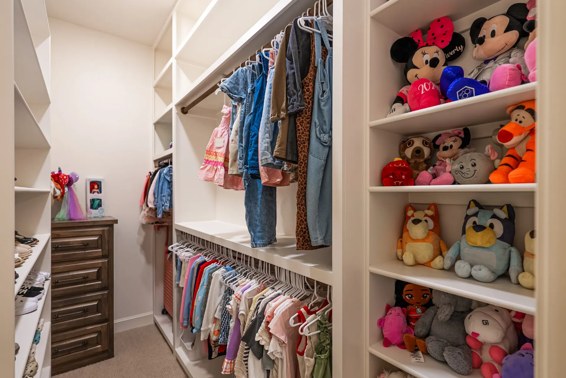 Walk-in closet at 1610 NW Eliam Dr with white built-in shelving and double hanging rods