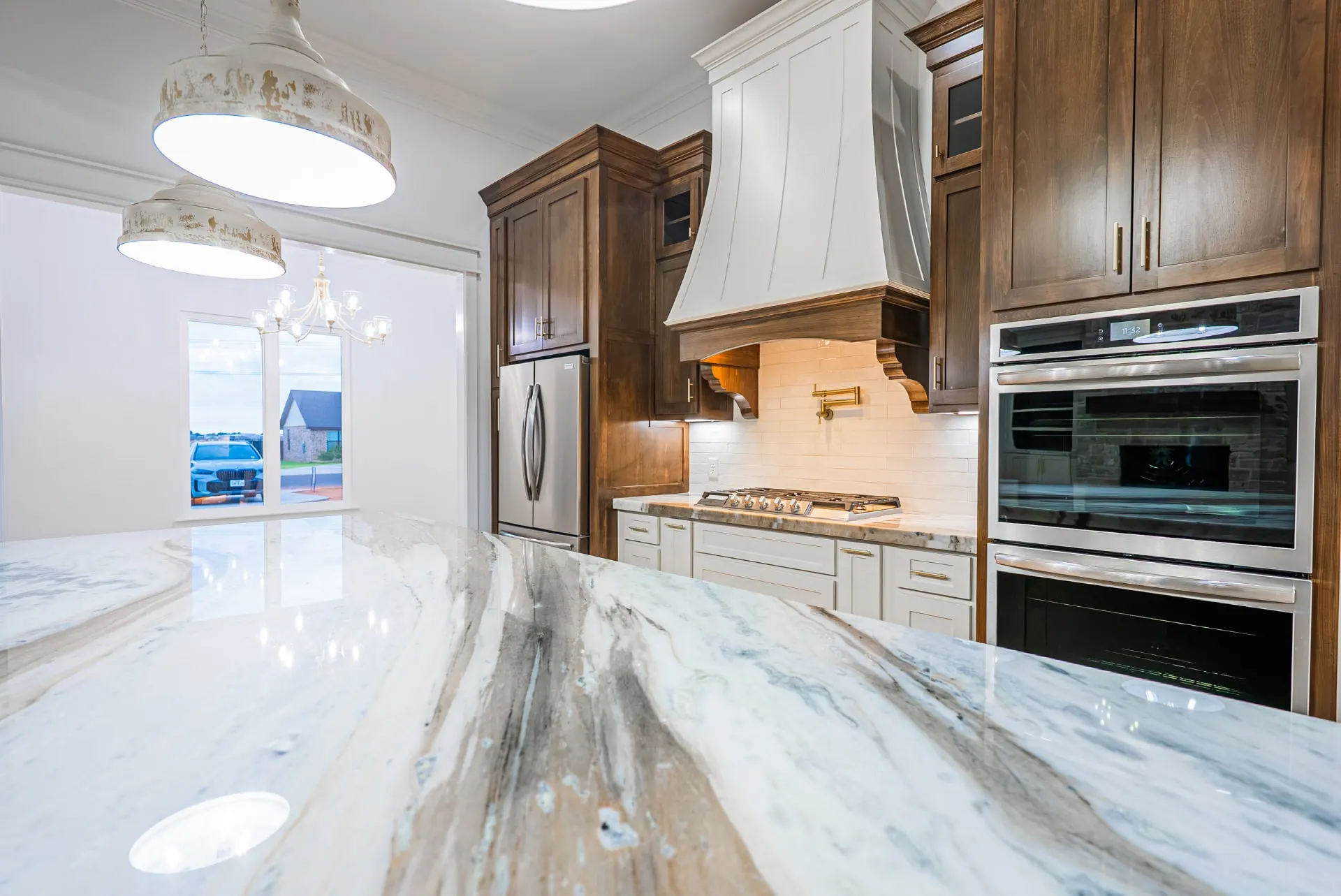 Marble island at 1607 NW 12th St beneath antique brass pendants