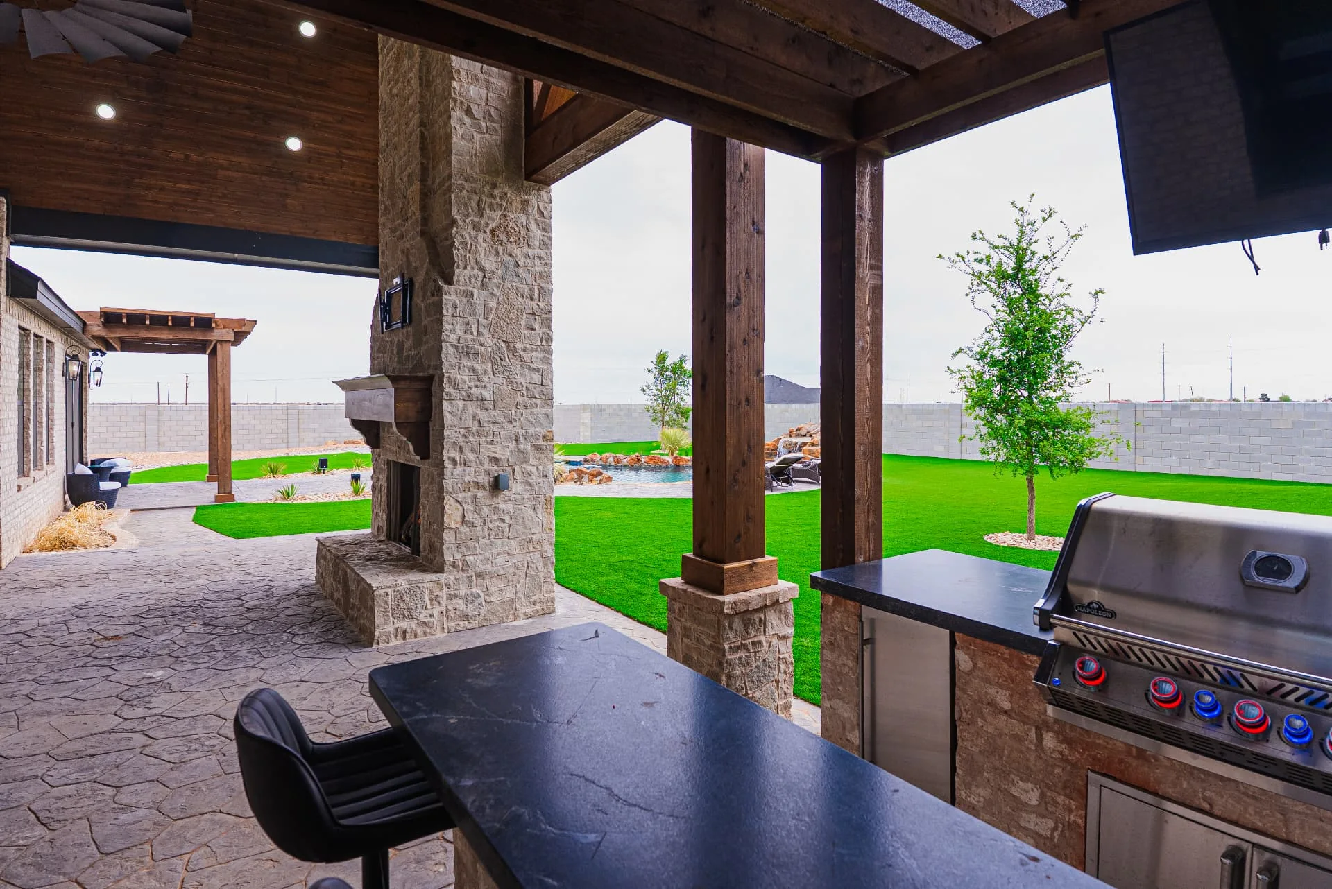 Outdoor counter and grill beside the covered patio at The Flores Estate