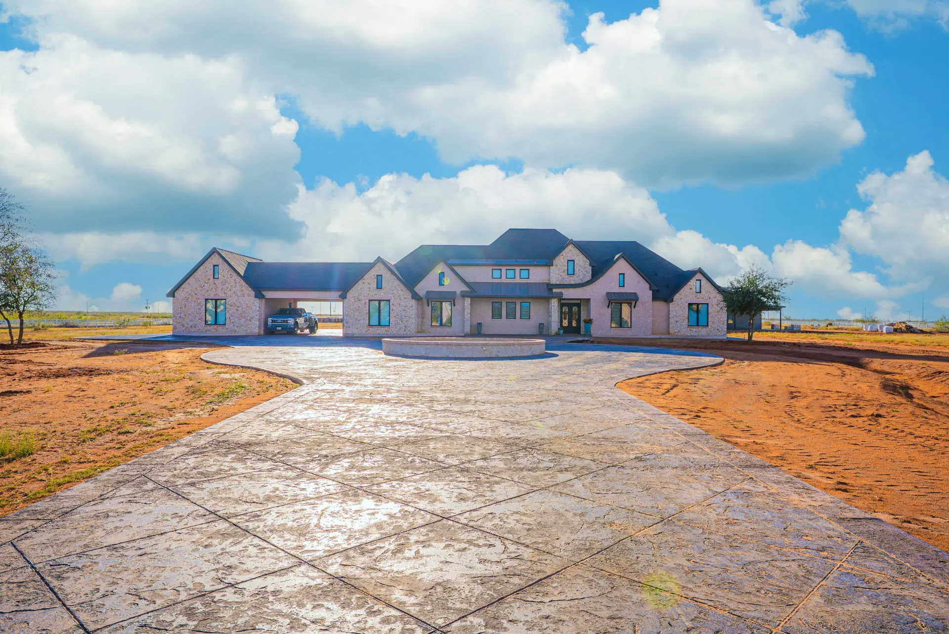 Front exterior of 5 Prairie Ln with stone gables and a curved stamped-concrete drive
