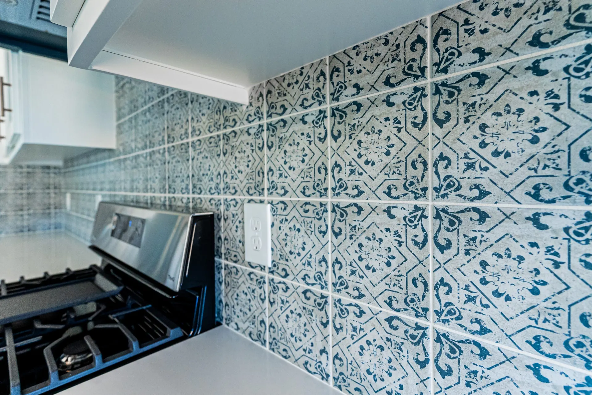 Close detail of the blue patterned backsplash tile at 718 K Ave