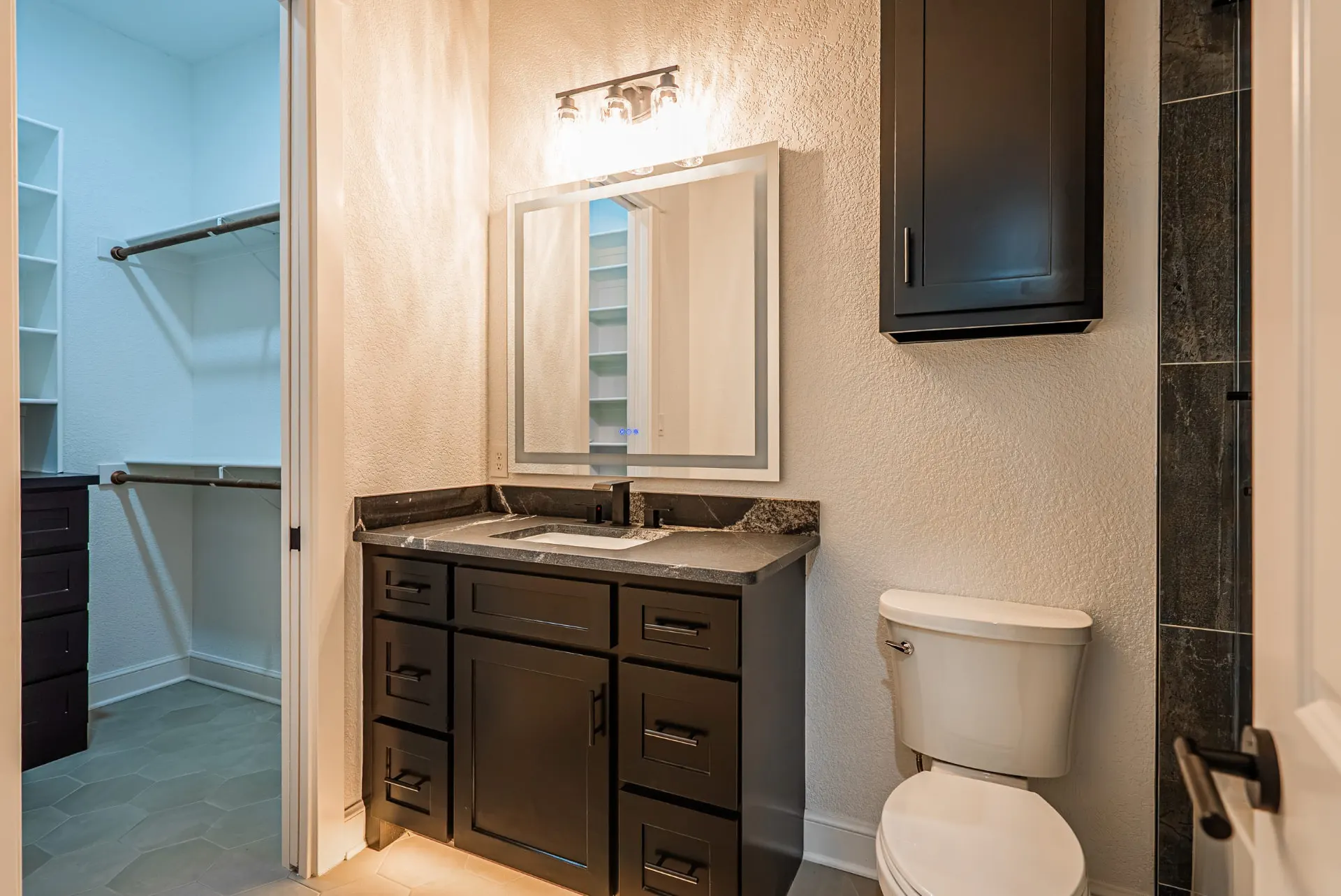 Bedroom with LED tray lighting, black ceiling fan and wood-look tile at 1607 NW 12th St