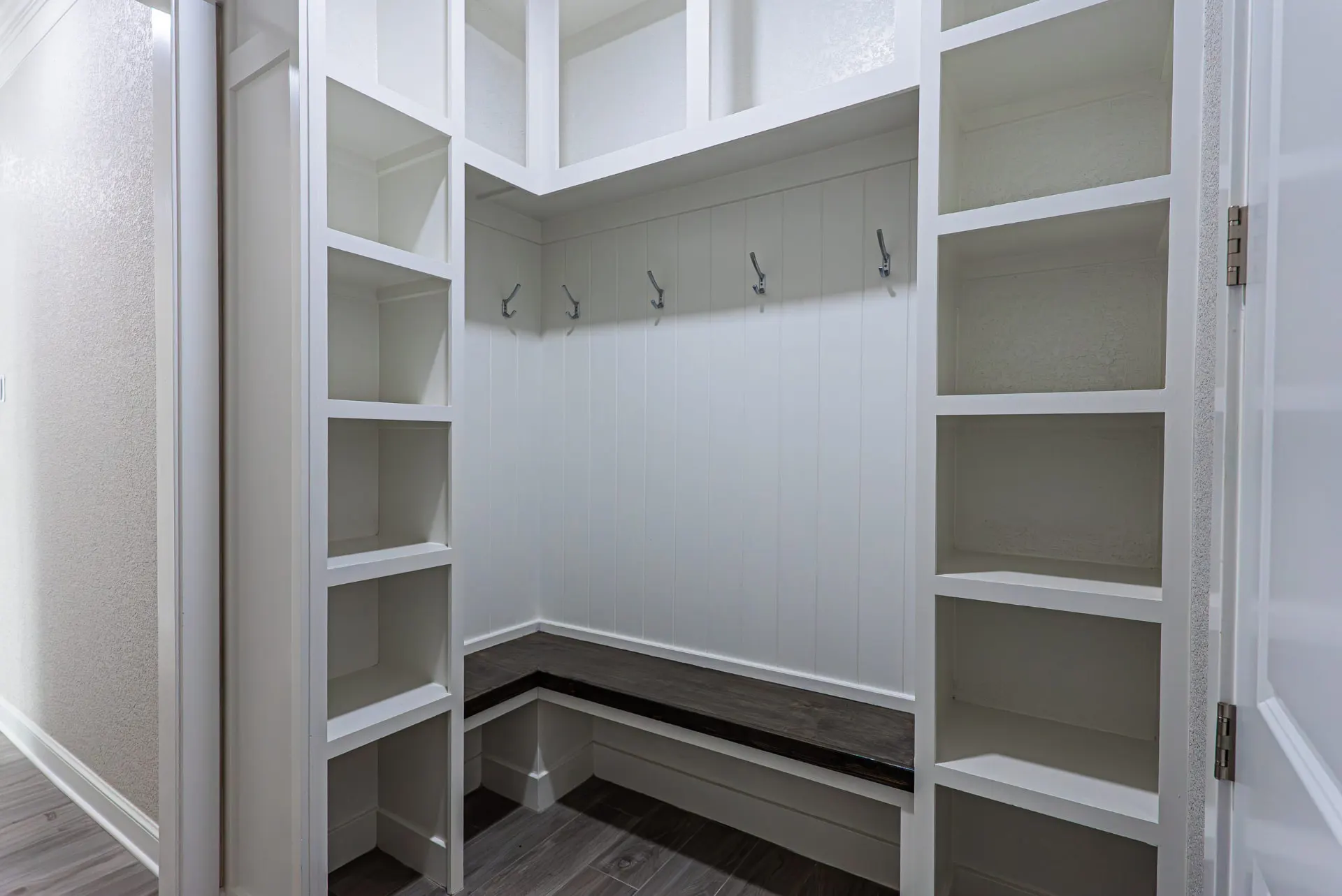 Mudroom at 27 Santiago Mission Dr with a wood bench, shiplap wall, coat hooks and floor-to-ceiling cubbies