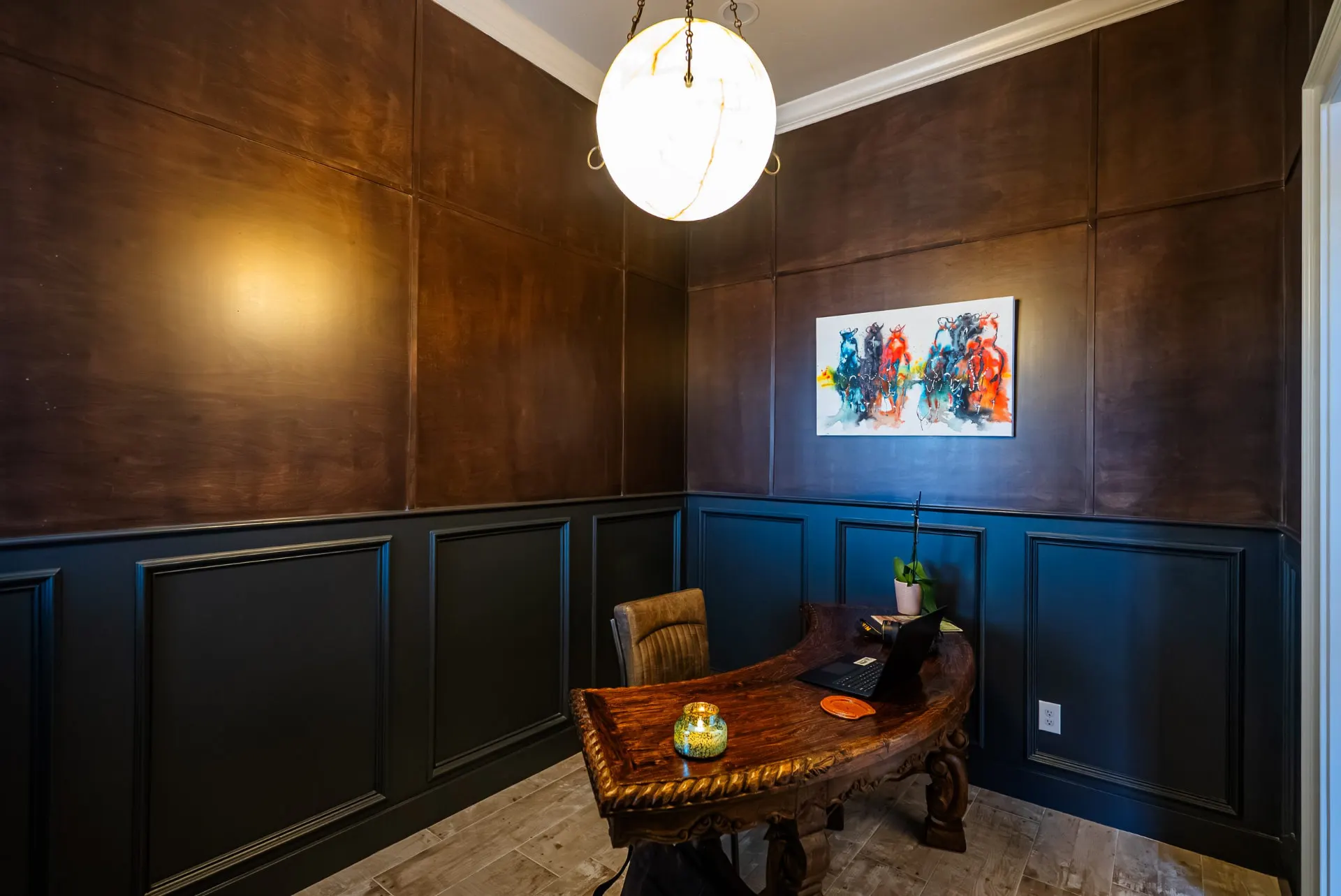 Home office at 5 Prairie Ln with stained wood panels and navy wainscoting