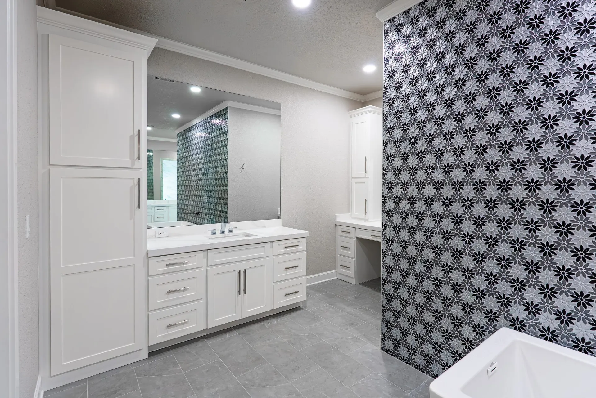 Primary bath vanity, makeup desk and floral mosaic wall at 27 Santiago Mission Dr